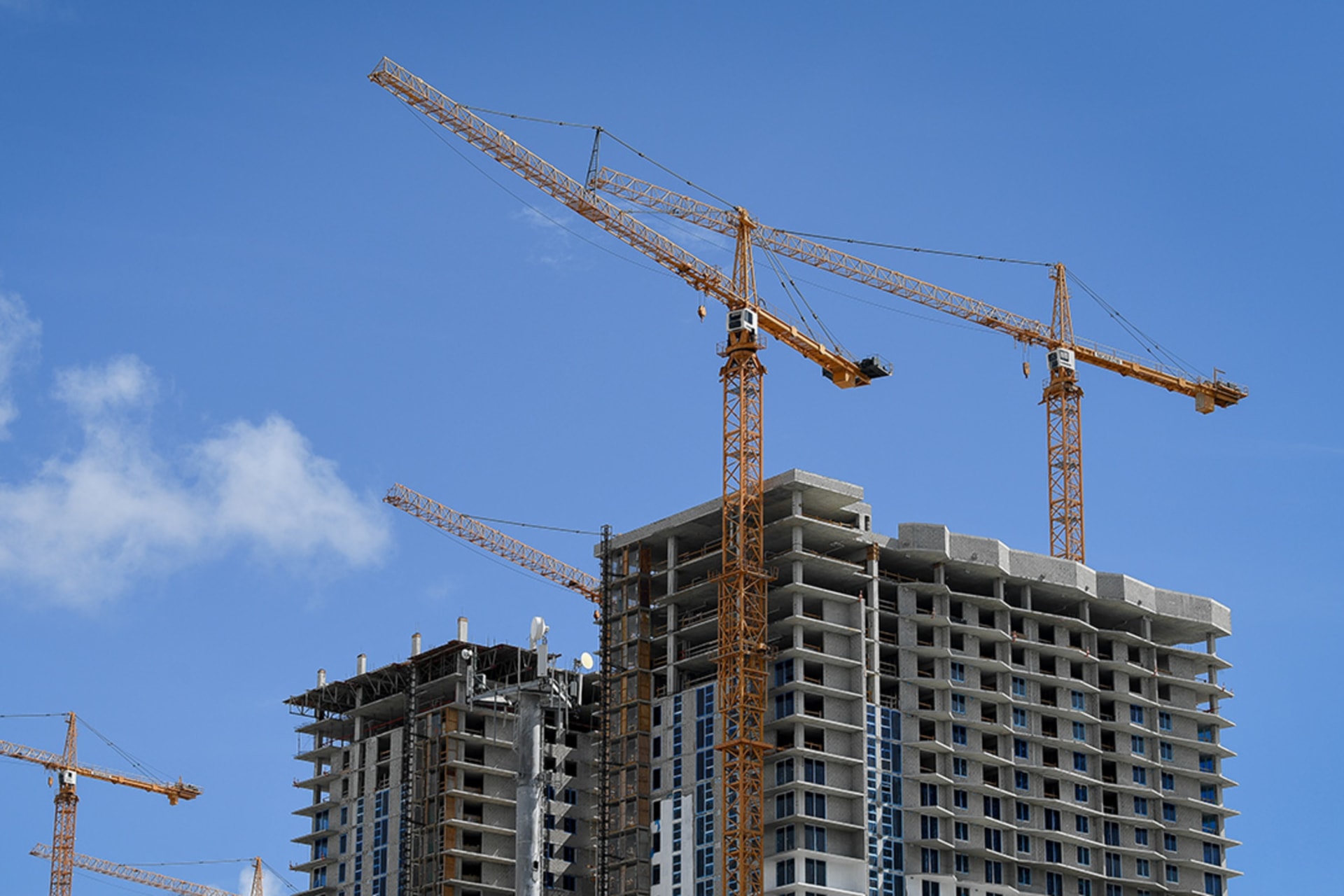 <p>Construction towers loom above the skyline in Miami, Florida.</p>