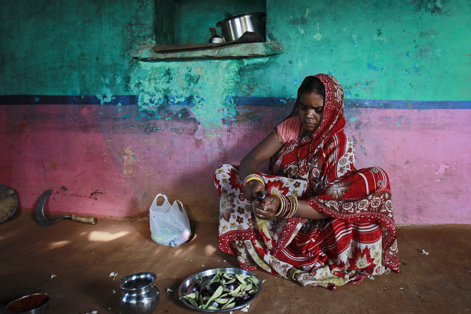 <p>Krishna, 13, cuts vegetables inside the kitchen at her house in a village near Baran, located in the northwestern state of Rajasthan, July 17, 2012. Krishna married her husband Gopal when she was 11 and he was 13.</p>
