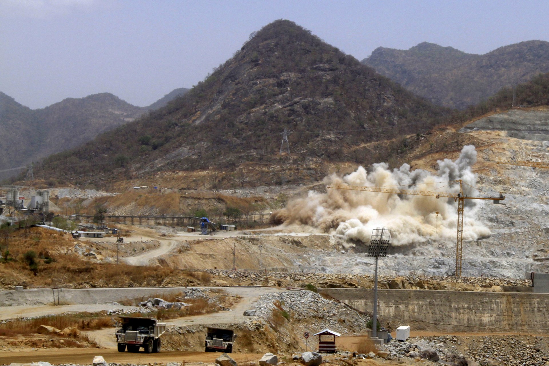 <p>A cloud of dust rises from a dynamite blast, as part of construction work, at Ethiopia’s Grand Renaissance Dam during a media tour along the river Nile in Benishangul Gumuz Region, Guba Woreda, in Ethiopia (Tiksa Negeri/Reuters).</p>