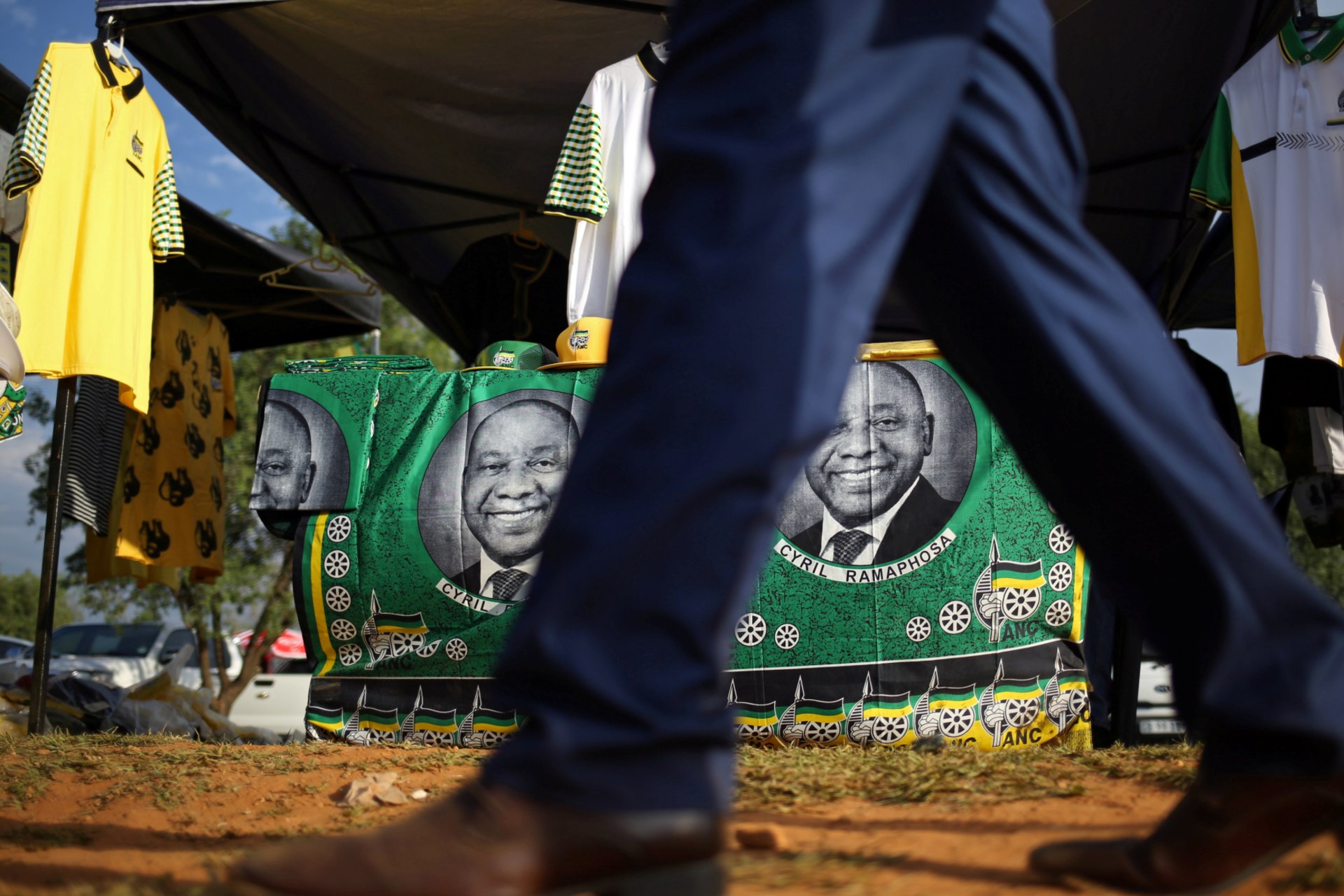 <p>A man walks past ANC merchandise with the face of newly elected president Cyril Ramaphosa outside the venue of the 54th National Conference of the ruling African National Congress (ANC) at the Nasrec Expo Centre in Johannesburg, South Africa.</p>