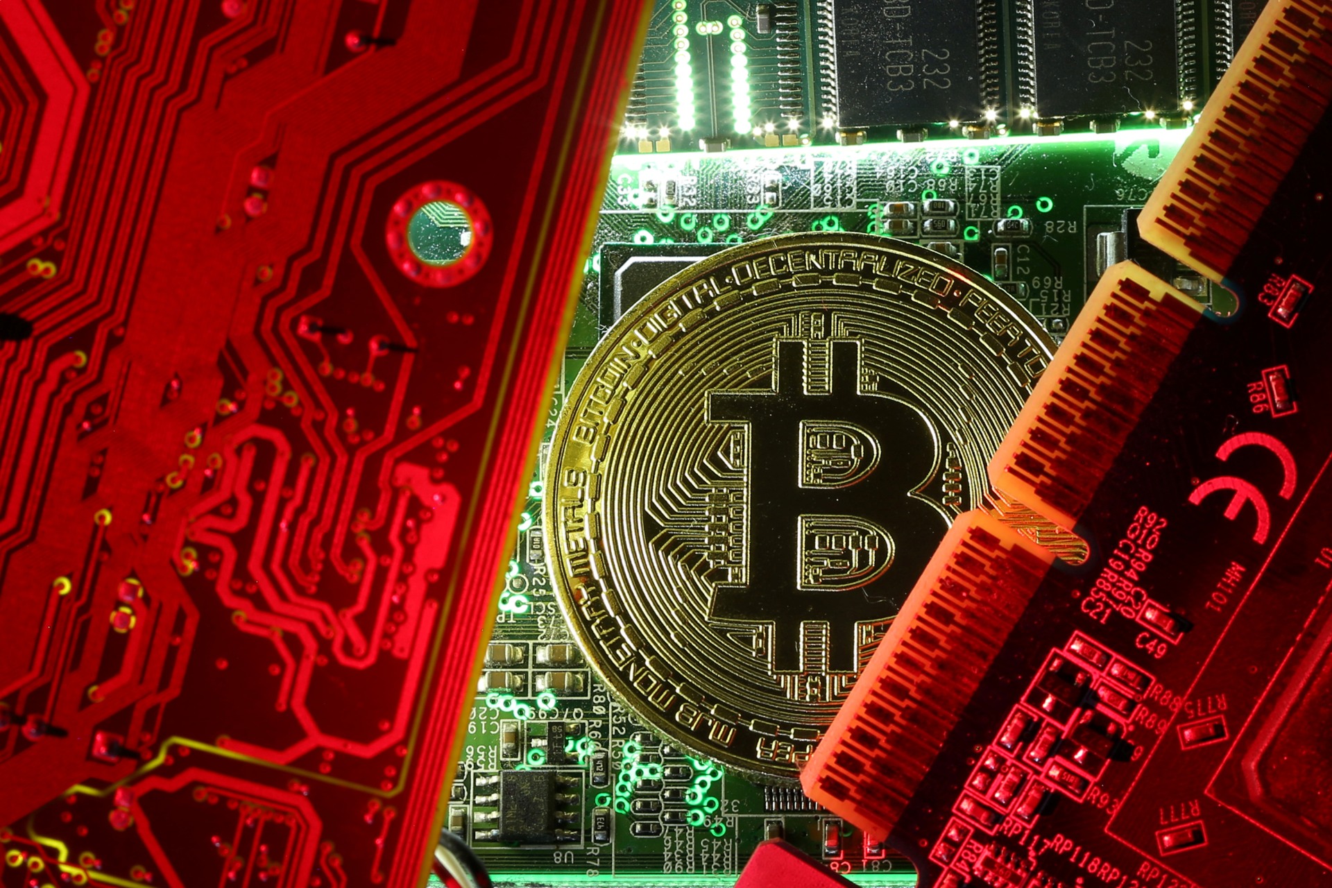 <p>A coin representing the bitcoin cryptocurrency is seen on computer circuit boards in this illustration picture, October 26, 2017.</p>

