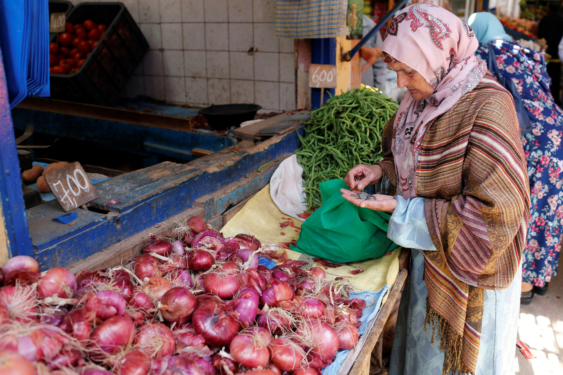 <p>A women counts coins in a vegetable market in Casablanca, Morocco, June 29, 2017. Lawmakers have recently debated legislation that would legally protect women from harassment on streets and in public spaces.</p>
