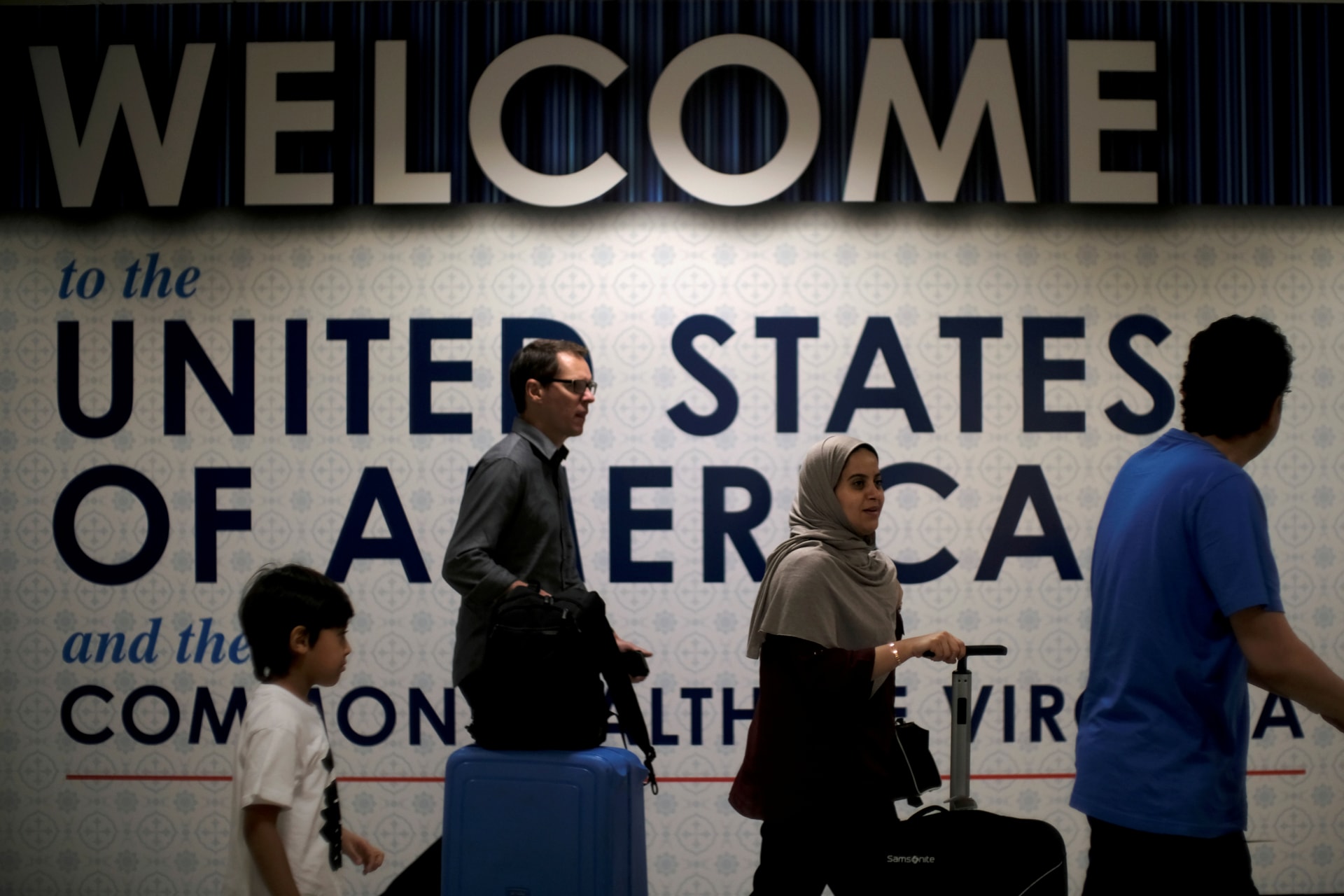 <p>International passengers arrive at Washington Dulles International Airport after the U.S. Supreme Court granted parts of the Trump administration’s emergency request to put its travel ban into effect in June, pending further judicial review </p>
