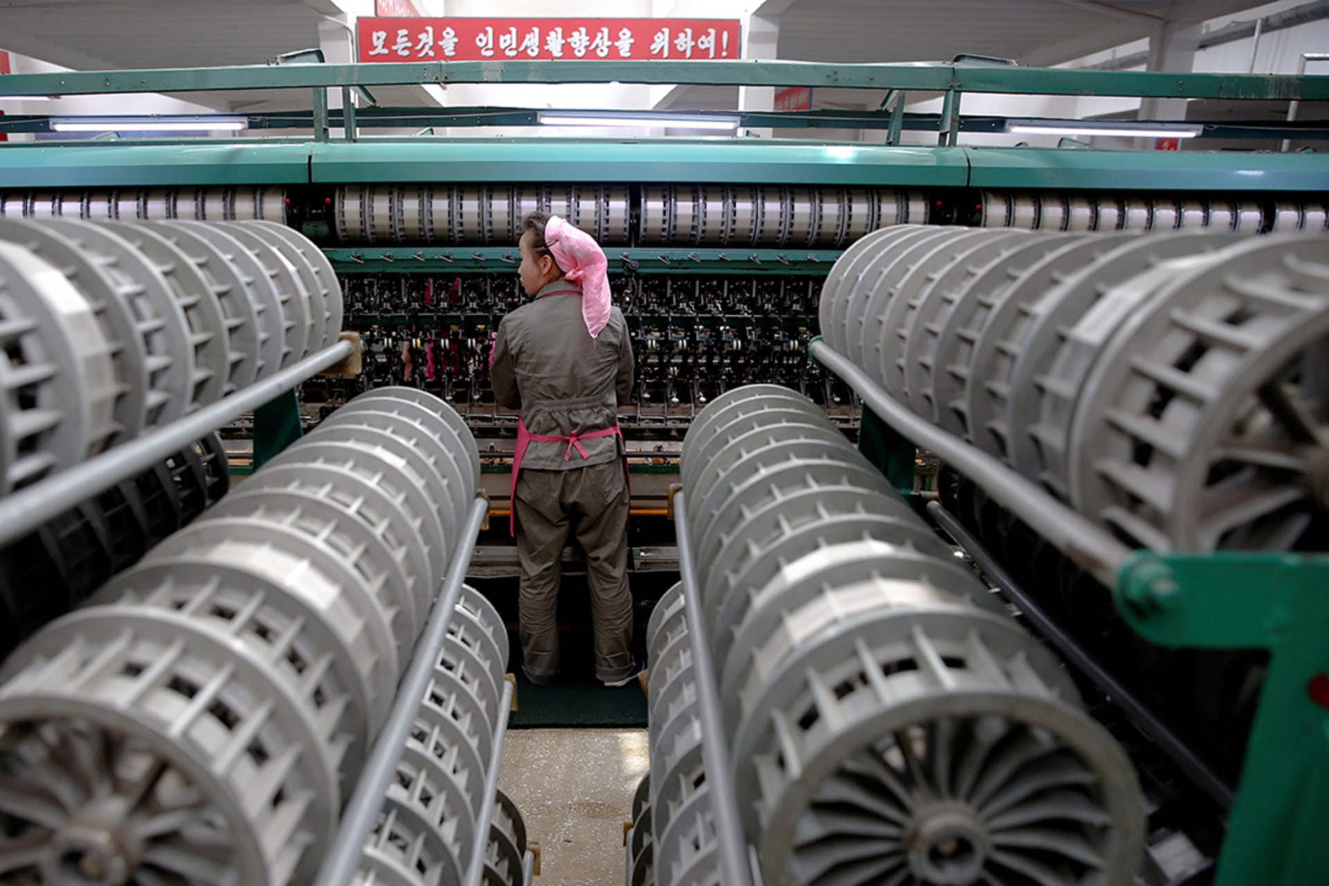 <p>A woman works at a textile mill in Pyongyang, North Korea. </p>