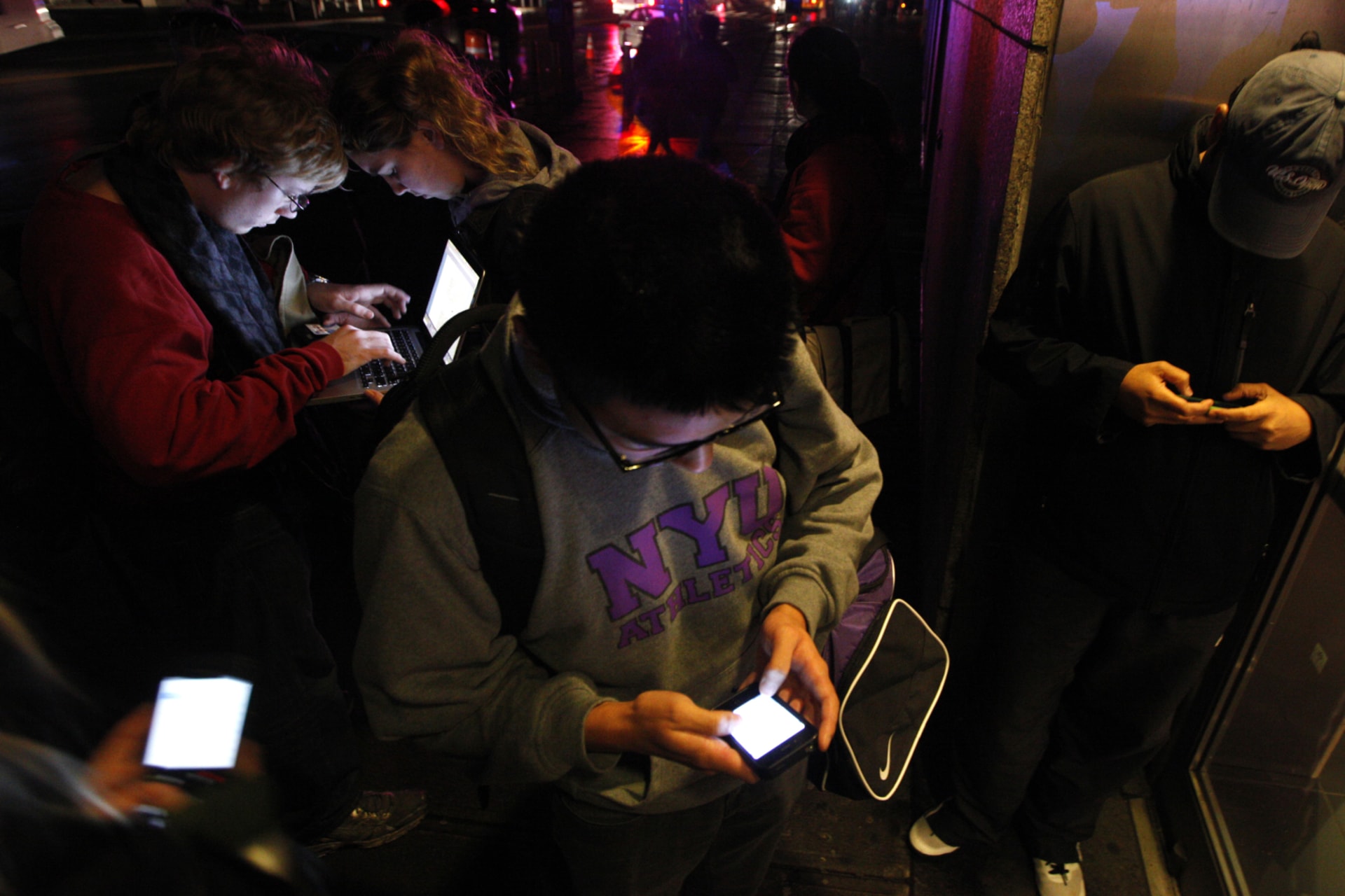 <p>People congregate near a building providing free wifi in the aftermath of Hurricaine Sandy in New York City in 2012. </p>