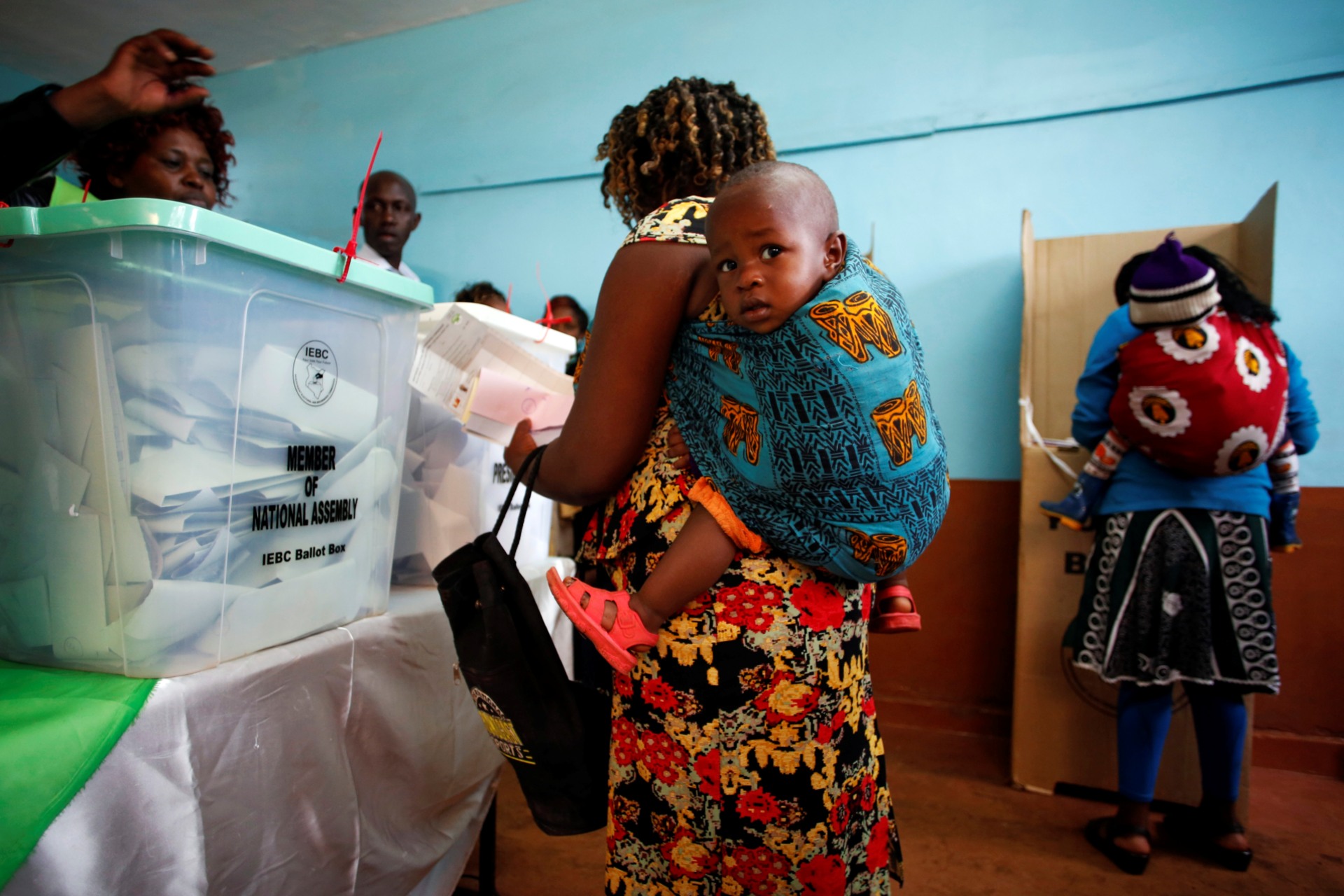 <p>Women carrying babies cast their vote in Gatundu in Kiambu county, Kenya August 8, 2017. Kiambu is one of Kenya’s twenty-one counties where more women than men are registered to vote.</p>
