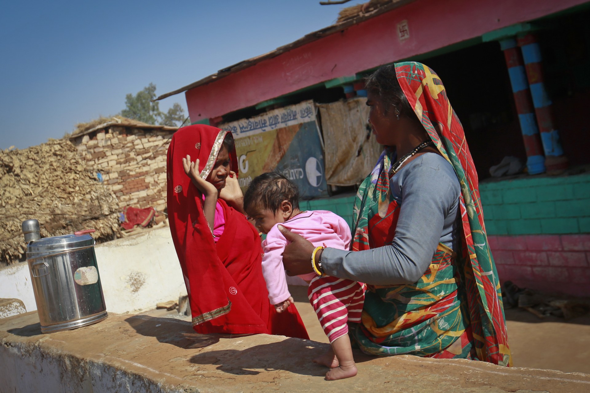 <p>Krishna, 14, holds her four-month-old baby at her house in a village near Baran, India. Krishna was married to her husband Gopal when she was 11. The legal age for marriage in India is 18, but marriages like these are common, especially in poor, rural are</p>
