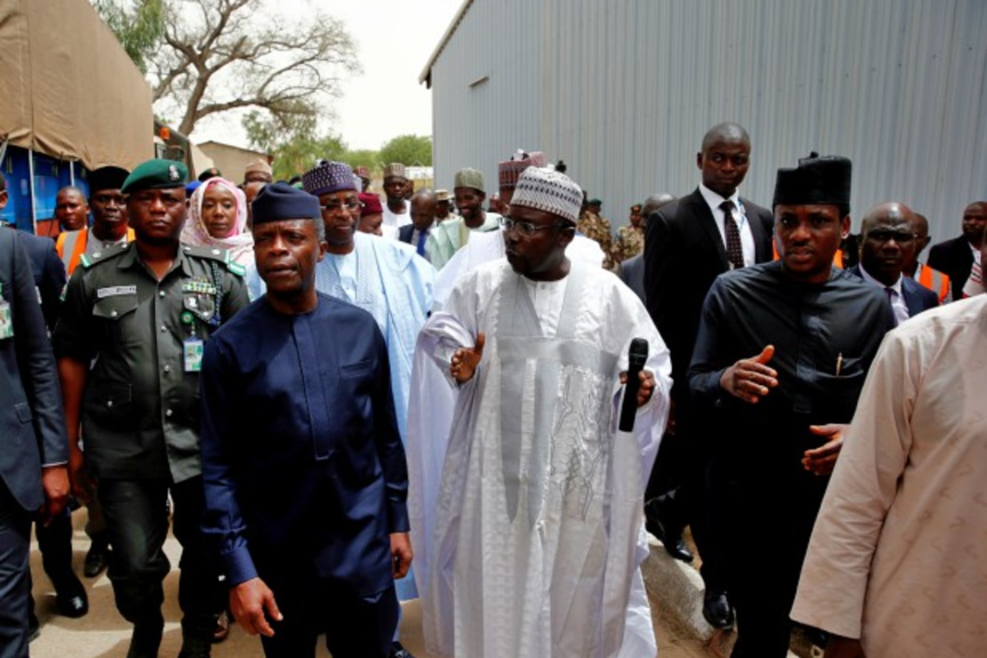 <p>Nigeria’s Vice-President Yemi Osinbajo (C) walks with other officials through a warehouse where food and relief materials for the internal displaced persons are stored on the outskirts of Nigerian city of Maiduguri, June 8, 2017</p>
