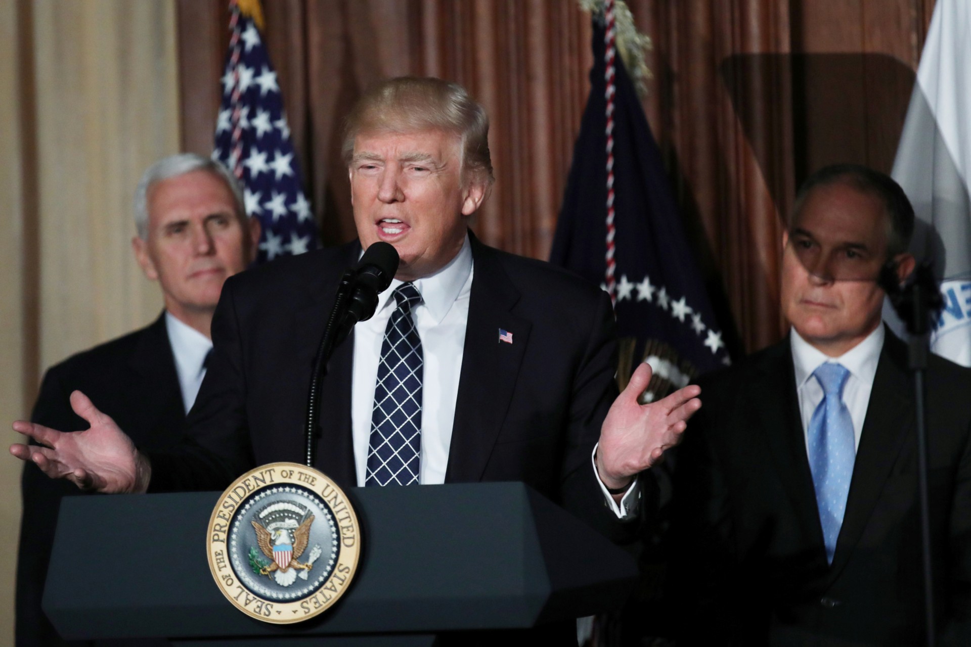 <p>President Donald Trump speaks between Vice President Mike Pence and EPA Administrator Scott Pruitt prior to signing an executive order on “energy independence,” eliminating Obama-era climate change regulations, during an event at the EPA</p>