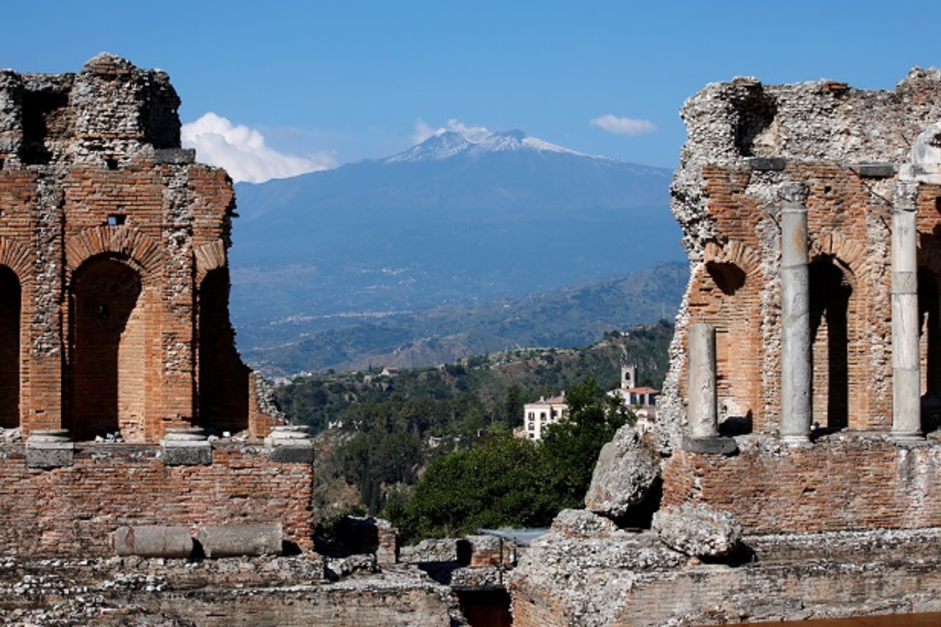 <p>Etna volcano is seen from the Greek theatre in Taormina, Italy. </p>
