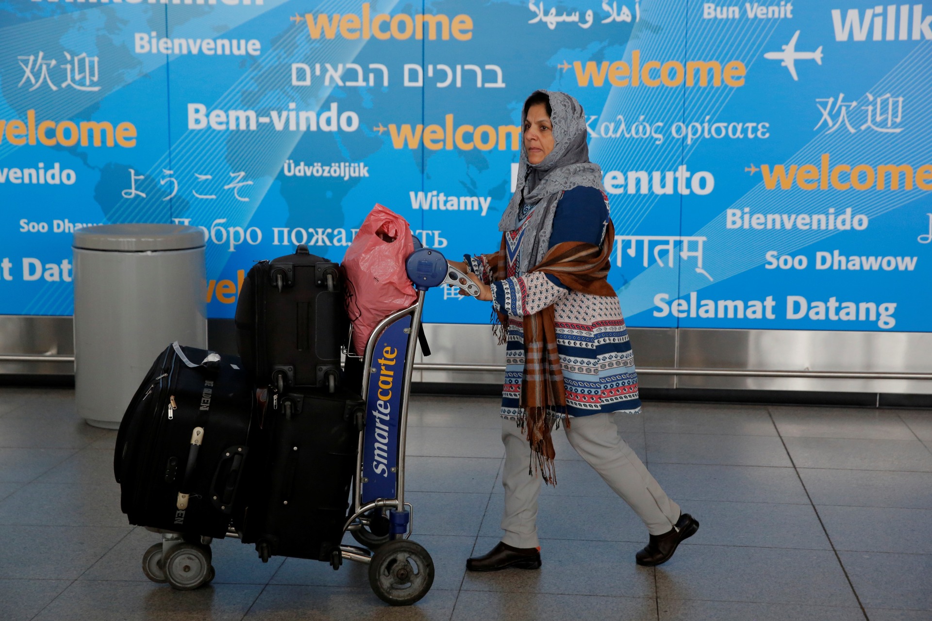 <p>A woman exits immigration after arriving at John F. Kennedy International Airport in Queens, New York, U.S., January 28, 2017. </p>
