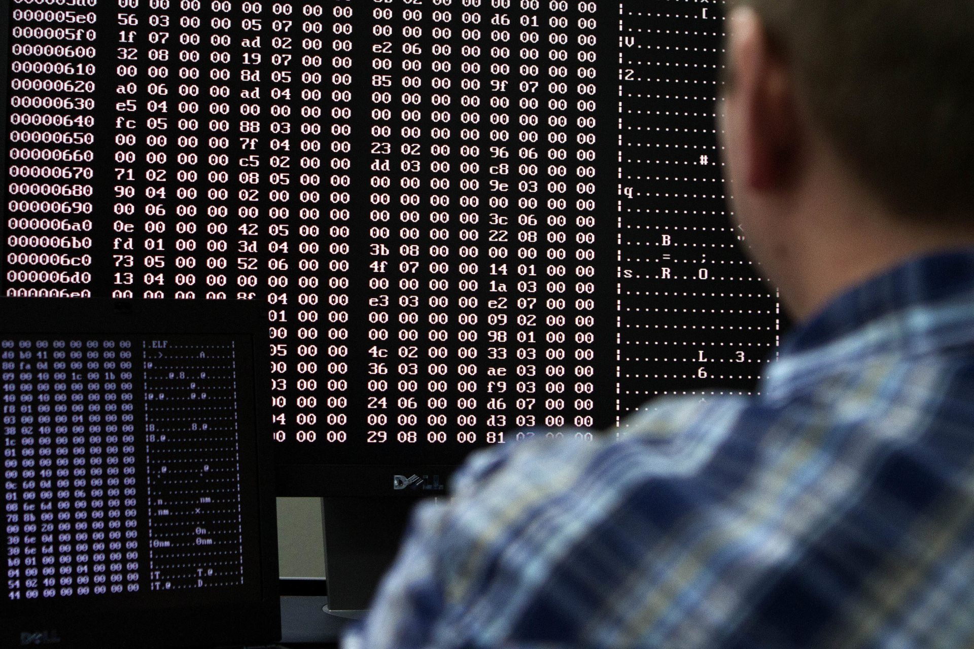 <p>An analyst looks at code in the malware lab of a cyber security defense lab at the Idaho National Laboratory</p>
