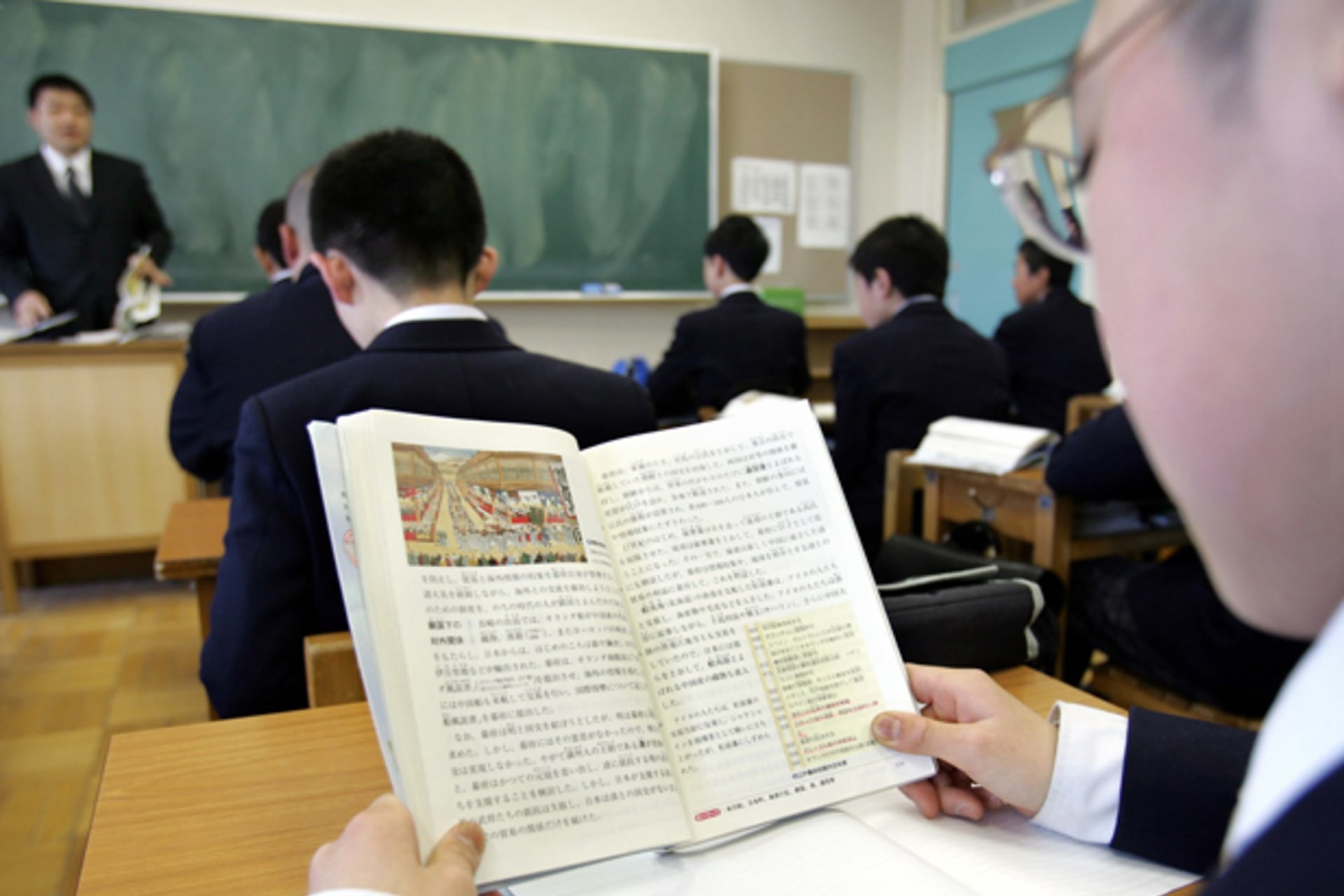 <p>A Japanese student reads a history textbook in a classroom at a junior high school in Tochigi, north of Tokyo, April 14, 2005.</p>