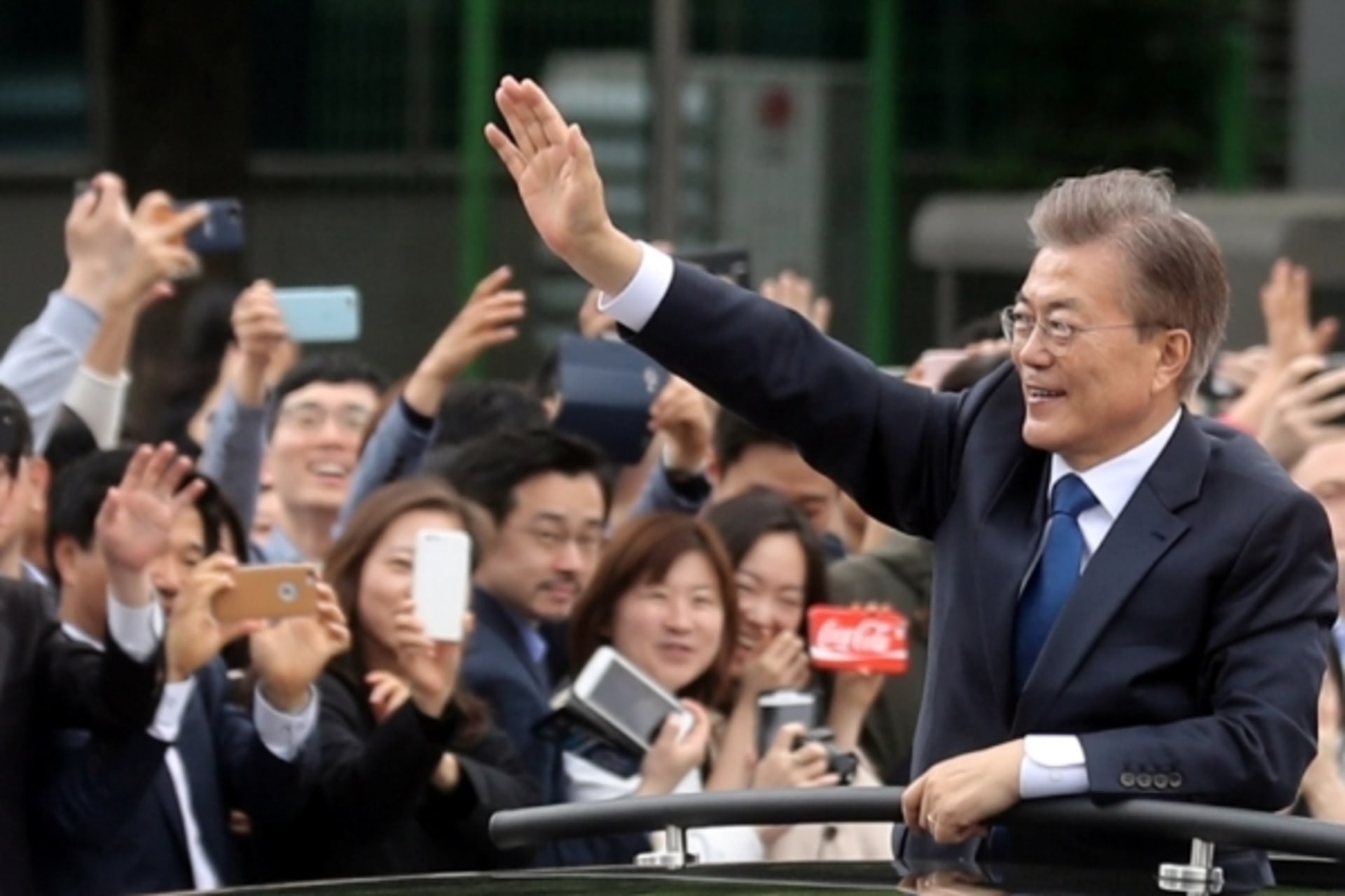 <p>South Korean President Moon Jae-in waves in a car as he heads to the presidential Blue House after his inaugural ceremony in Seoul, South Korea, May 10, 2017.</p>