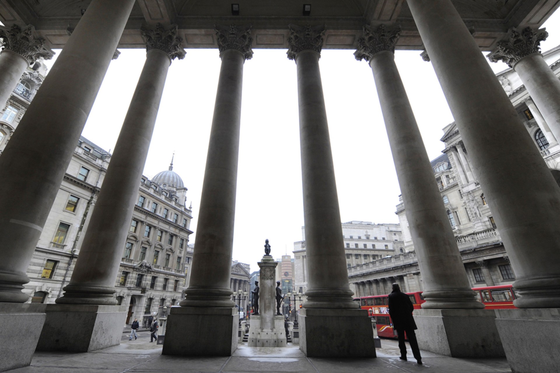 <p>People walk through the Royal Exchange in front of the Bank of England in central London.</p>
