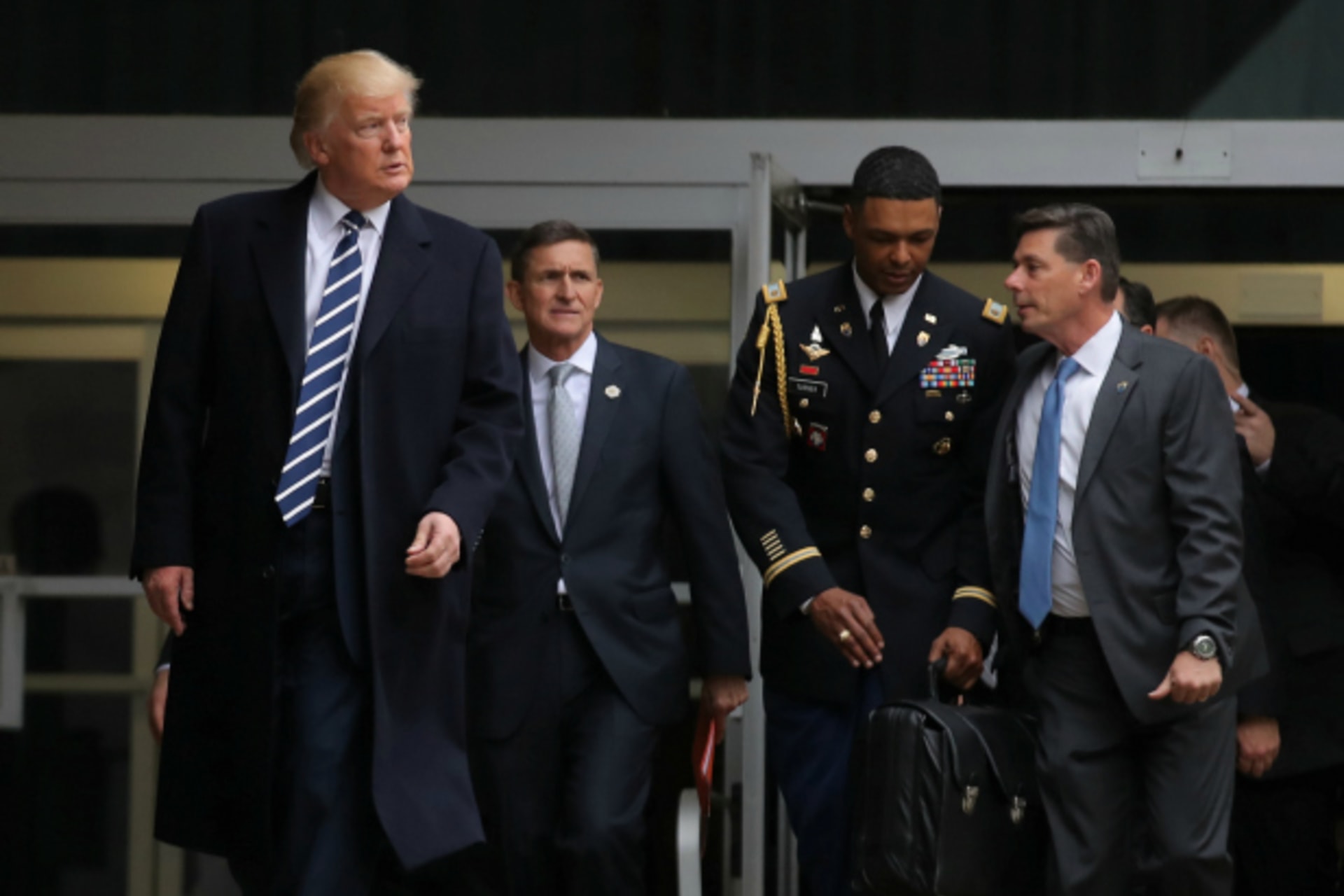 <p>U.S. President Donald Trump leaves the Central Intelligence Agency (CIA) headquarters accompanied by National security adviser General Michael Flynn (2nd L) after delivering remarks during a visit in Langley, Virginia (Carlos Barria/Reuters).</p>