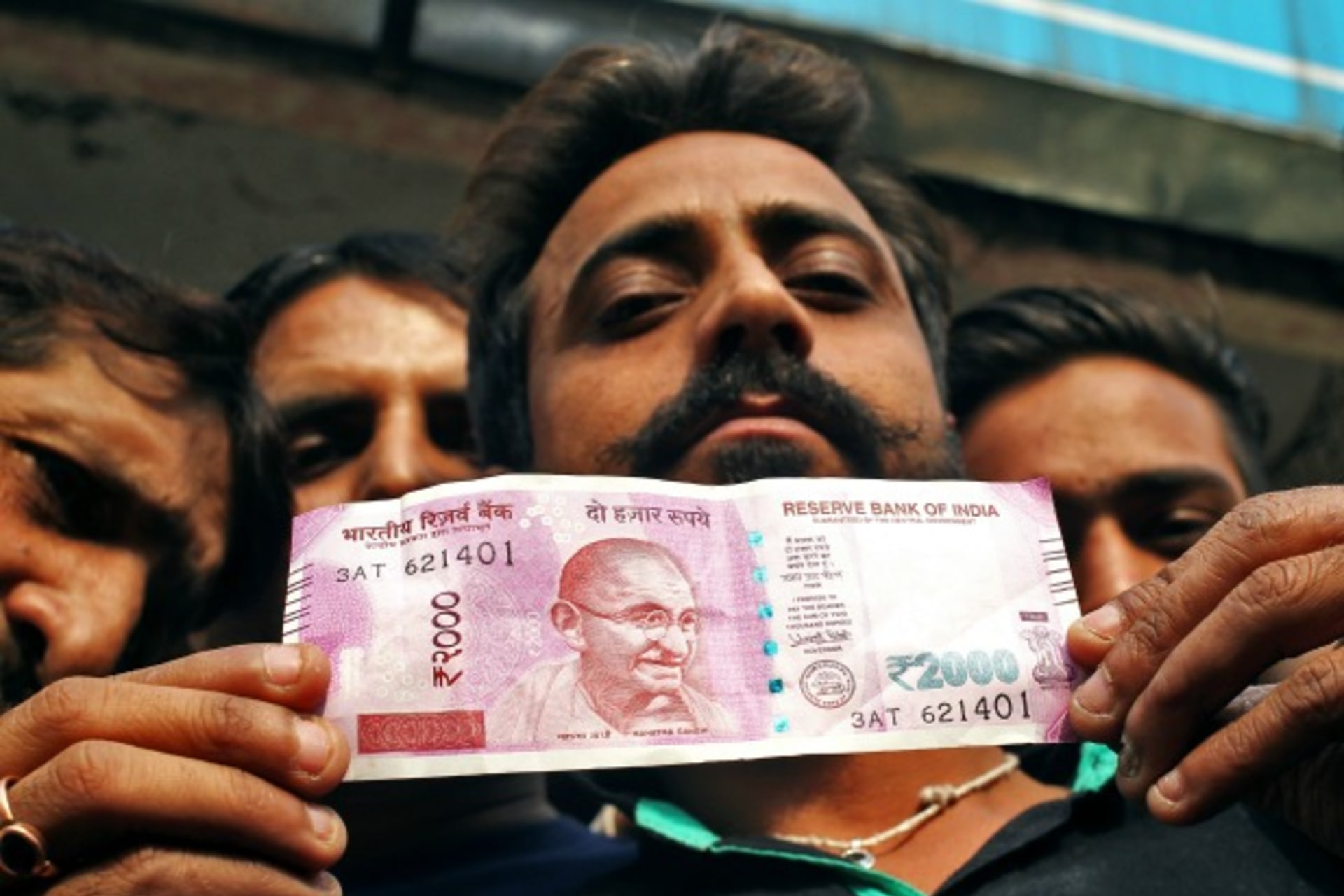 <p>A man displays a new 2000 Indian rupee banknote after withdrawing from a bank (Reuters/Mukesh Gupta).</p>
