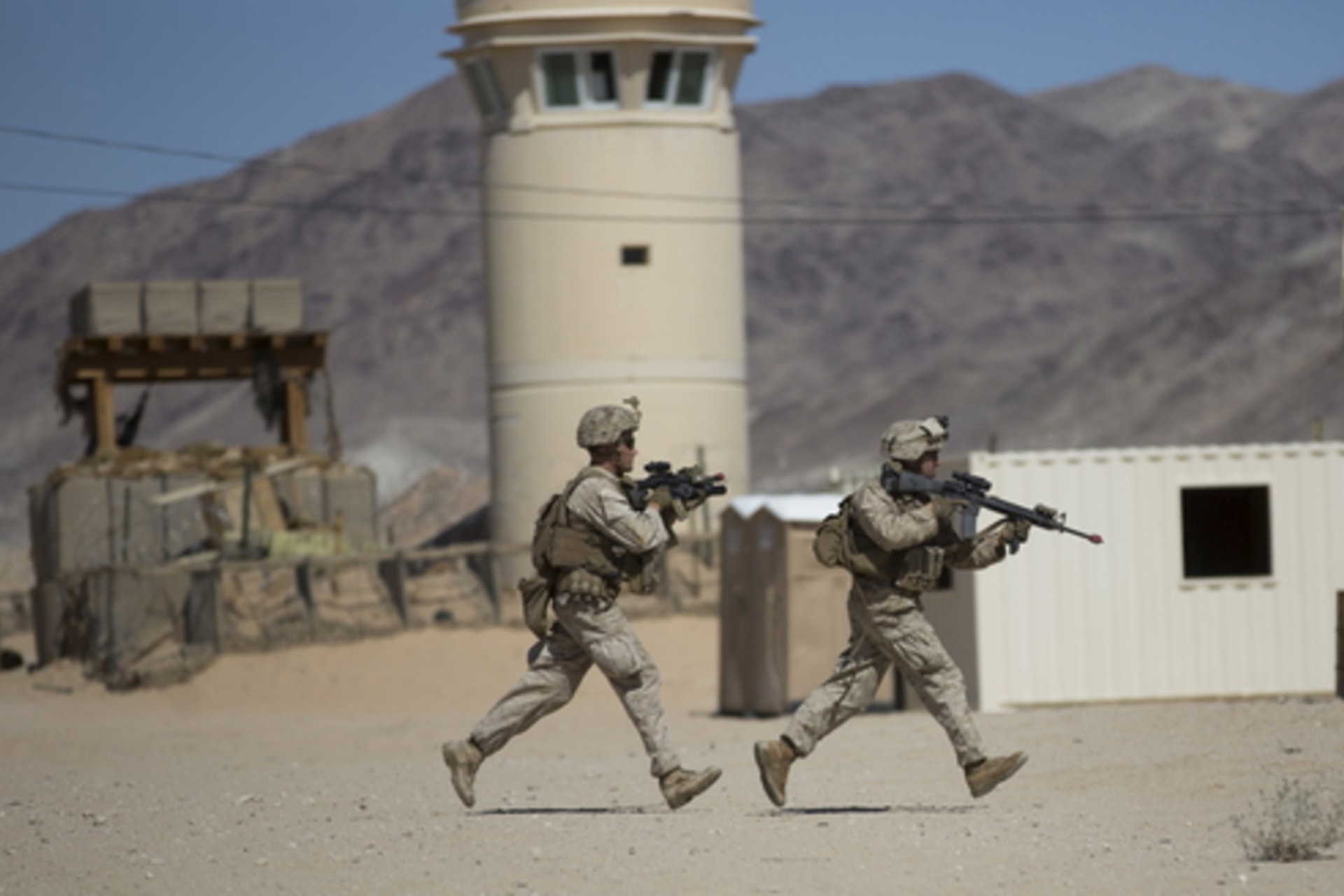 U.S. Marines from Fox Company, 2nd Battalion 1st Marines, 13th Marine Expeditionary Unit run for cover during a non-live fire MOUT training at US Marine Corps: Marines Air Ground Combat Center in Twentynine Palms