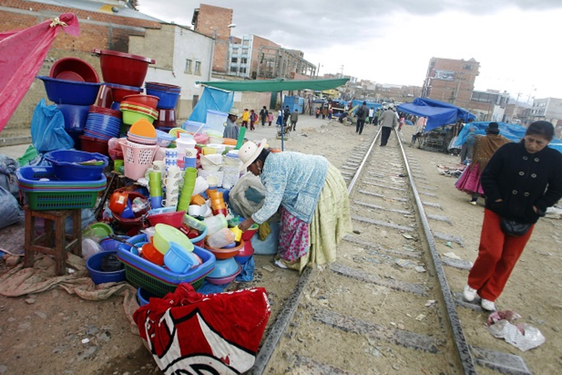 An Aymara woman displays her products next to a railway track in the market of El Alto on the outskirts of La Paz