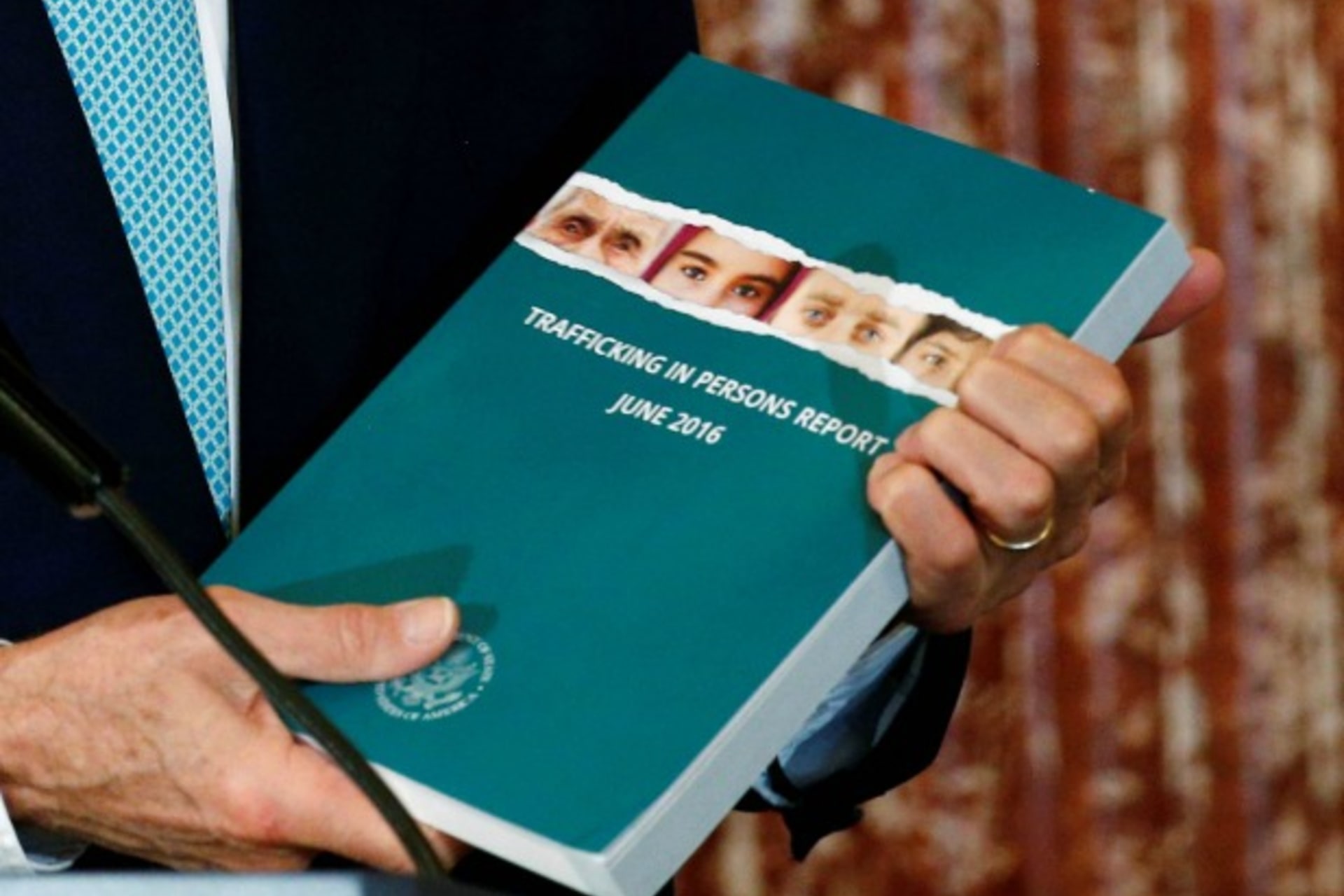 <p>U.S. Secretary of State John Kerry holds a copy of the 2016 Trafficking in Persons (TIP) report during the TIP Heroes Ceremony at the State Department in Washington, June 30, 2016 (Reuters/Kevin Lamarque).</p>
