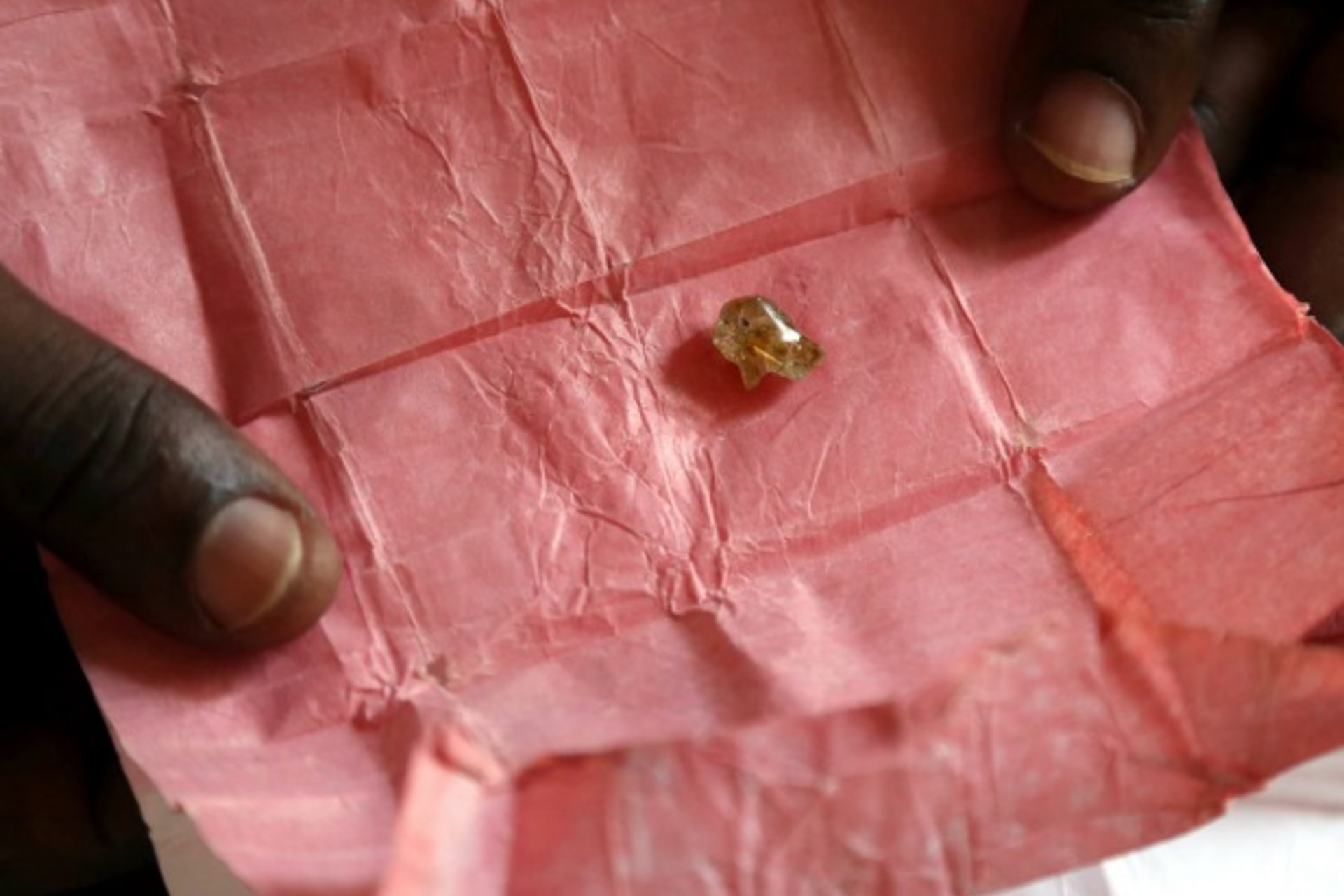 <p>A man displays a rough diamond, from the Boda region, for sale in Bangui May 1, 2014. Despite a 2013 ban on diamond exports by… in “blood diamonds”, rough diamonds are still commonly offered for sale in Central African Republic (Reuters/Emmanuel Braun).</p>
