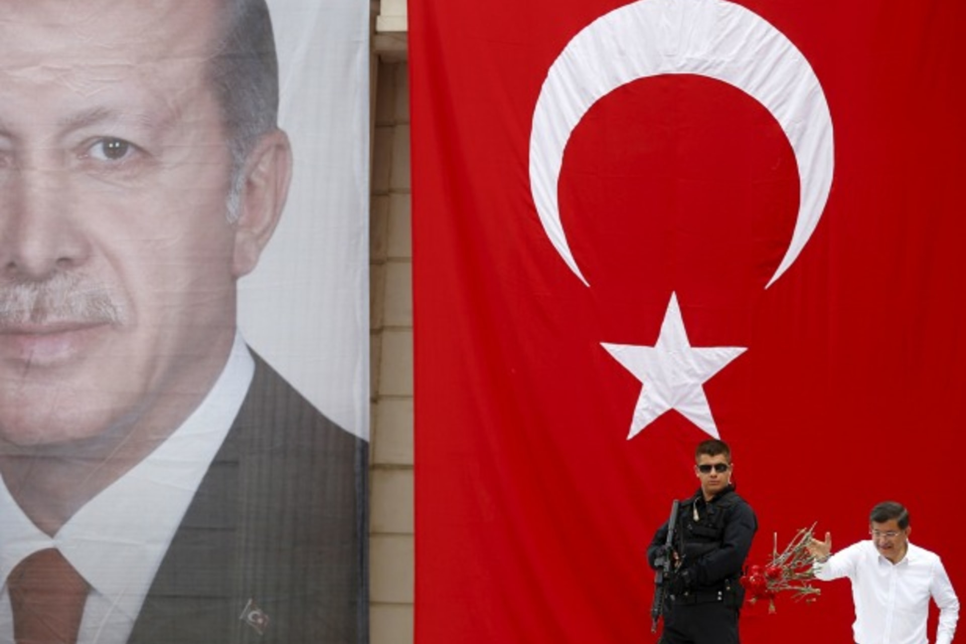 <p>Turkey’s Prime Minister Ahmet Davutoglu throws carnations to his supporters as he stands in front of a portrait of President T…g during an election rally for Turkey’s June 7 parliamentary election in Istanbul, Turkey, June 3, 2015. (Murad Sezer/Reuters)</p>
