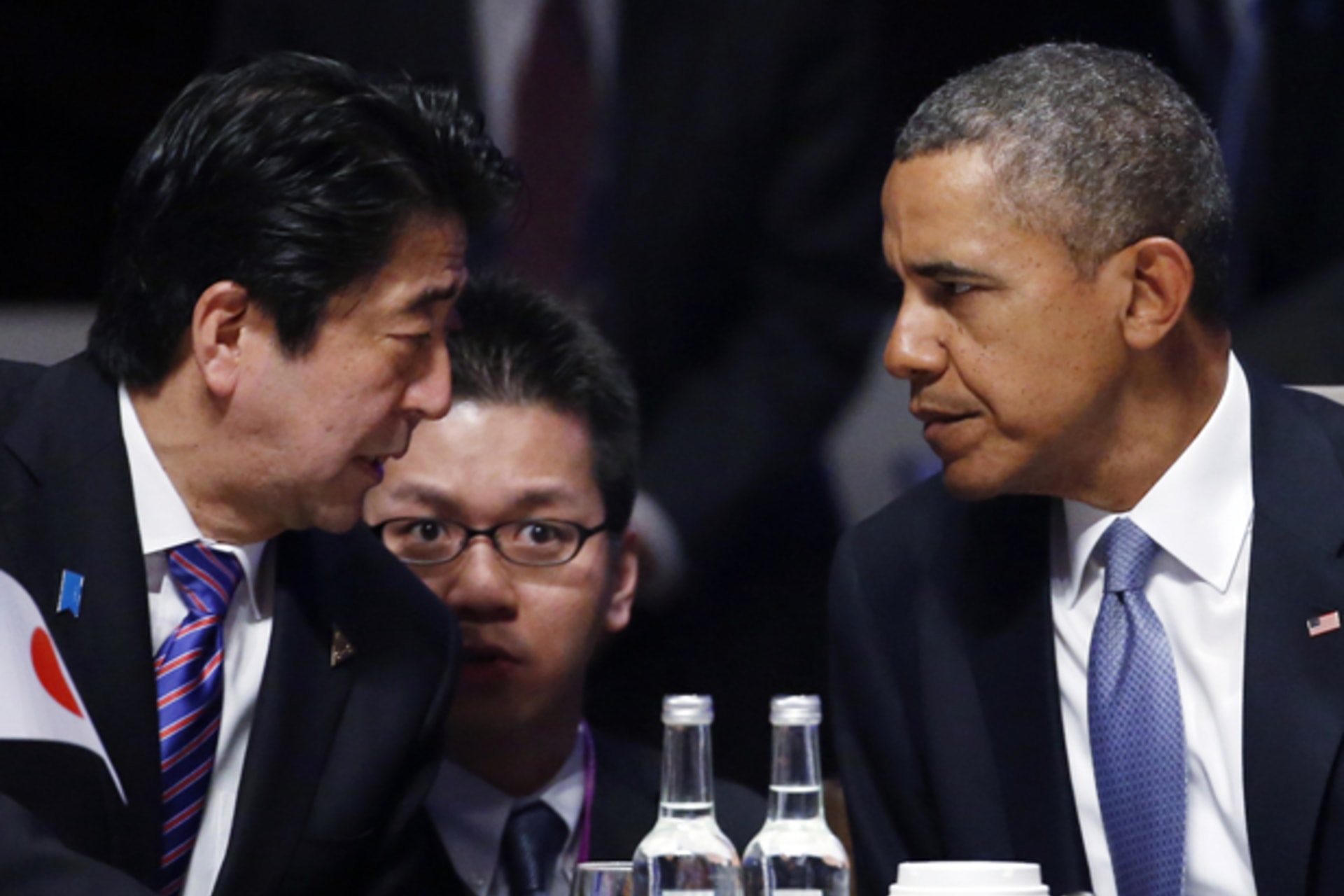 Japan's Prime Minister Shinzo Abe talks to U.S. President Barack Obama during the opening session of the Nuclear Security Summit in The Hague March 24, 2014 (Yves Herman/Courtesy Reuters).