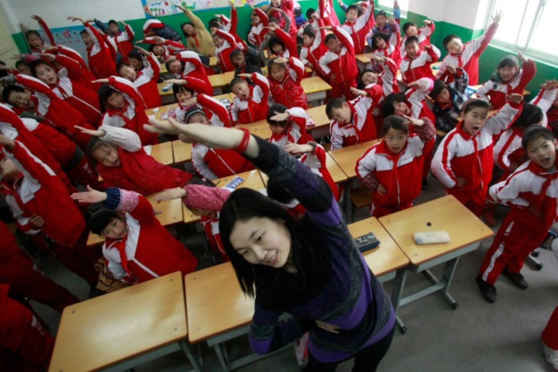 <p>A teacher leads her students in an exercise, Jinan, China, January 2013 (Courtesy Reuters/China Daily).</p>