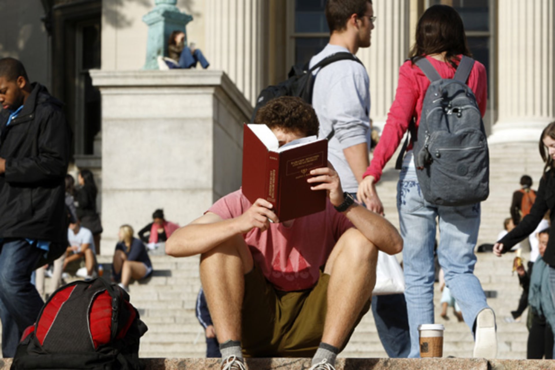 <p>A student reads on the campus of Columbia University in New York (Mike Segar/Courtesy Reuters).</p>
