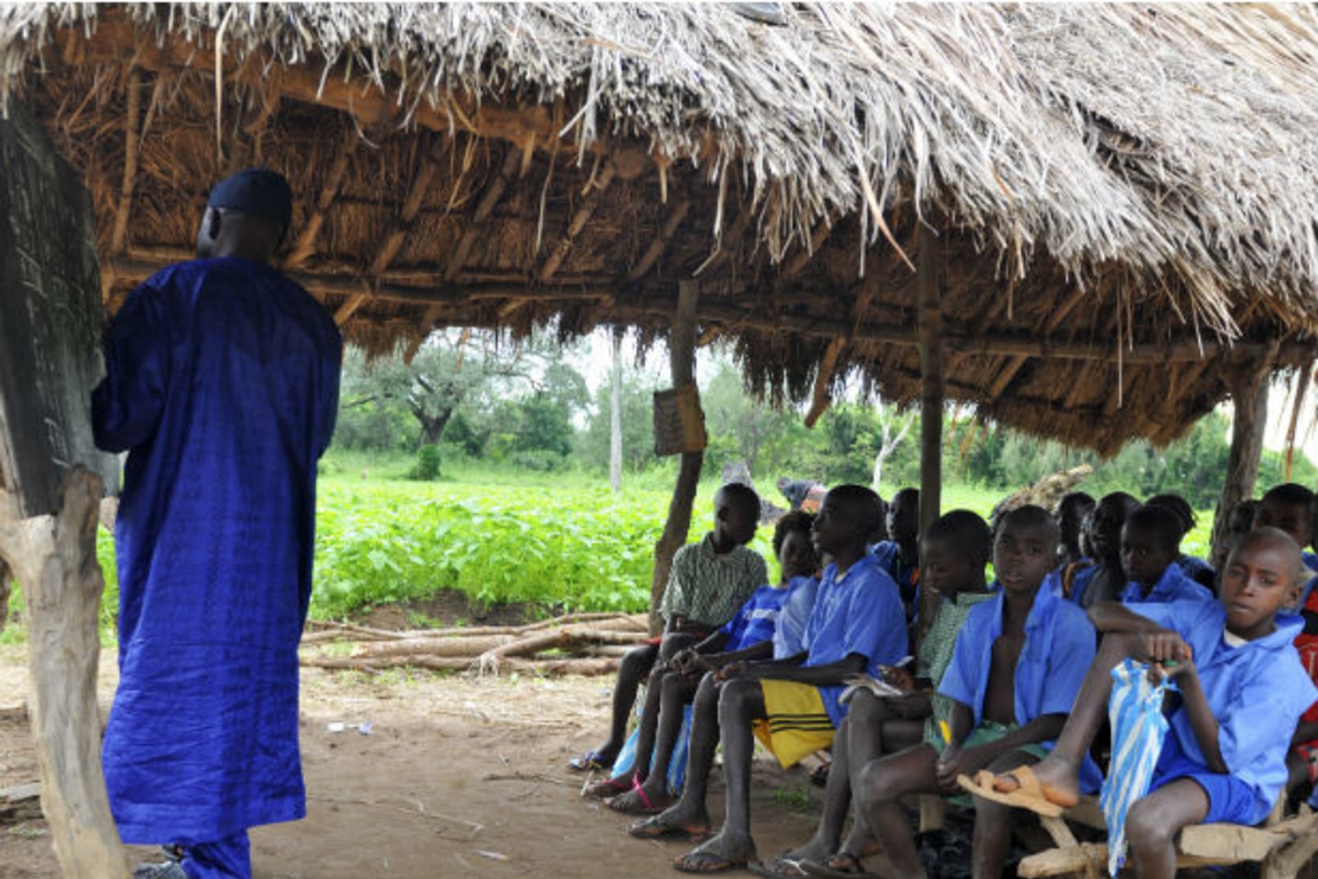 <p>A teacher conducts a lesson under a makeshift classroom at a relief centre for flood victims at St. Boniface primary school in Idah in Nigeria’s central state of Kogi on October 3, 2012 (Afolabi Sotunde/Courtesy Reuters).</p>