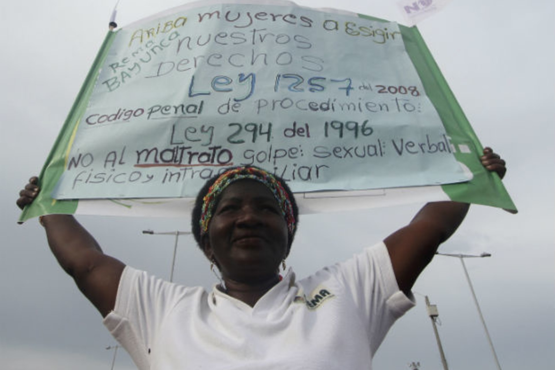 <p>A woman holds a banner during a protest against all forms of violence calling for respect for the rights of women, in Cartagena, Colombia on July 5, 2012 (Joaquin Sarimento/Courtesy Reuters).</p>