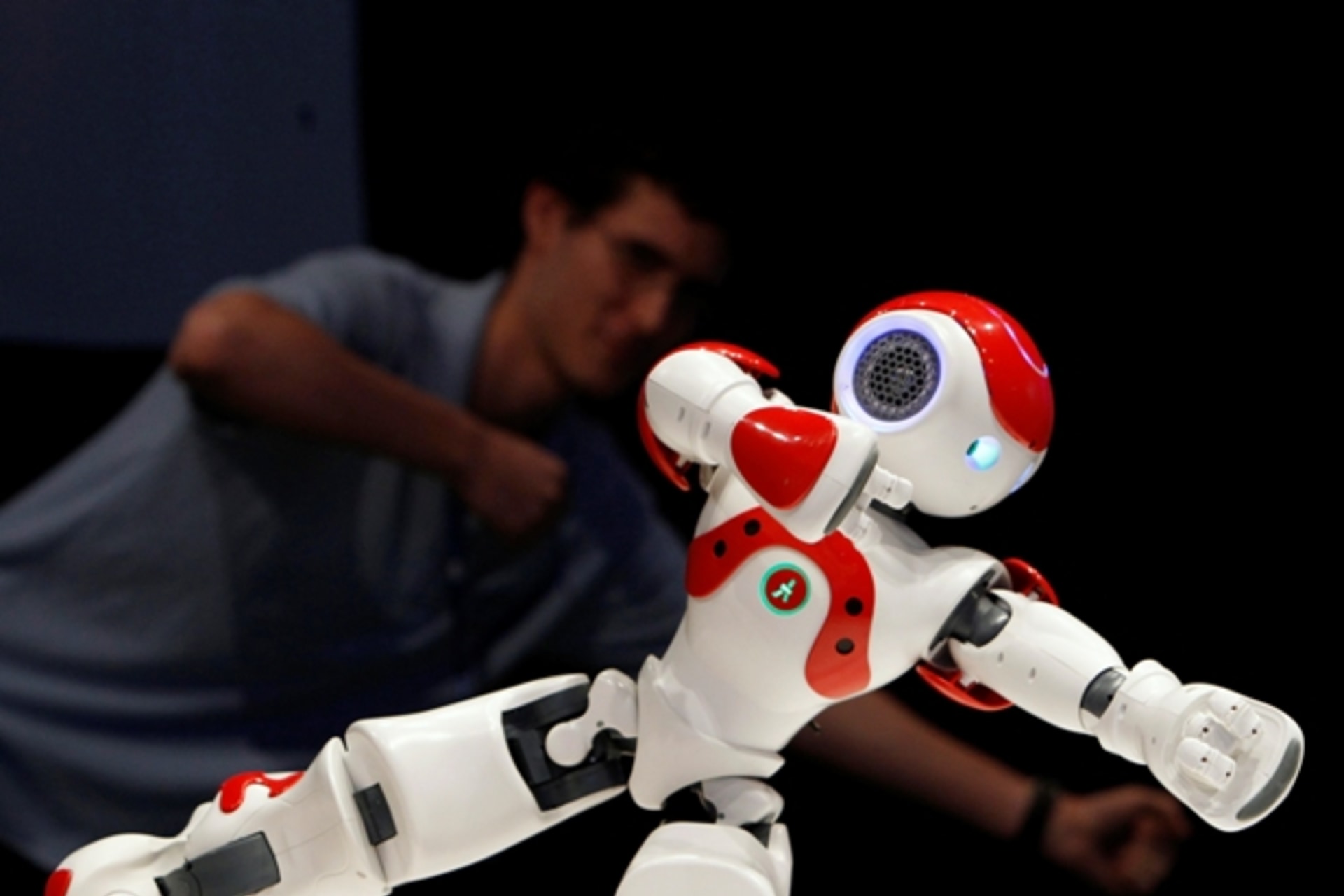 <p>A museum guide imitates a humanoid robot at the Robotic World exhibition in Haifa (Courtesy Reuters).</p>