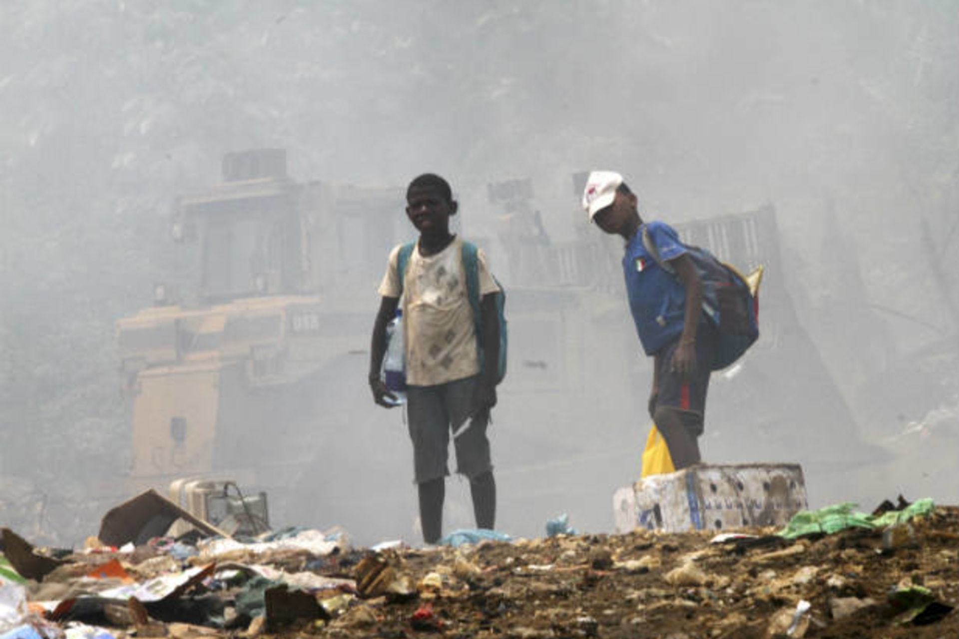 <p>Children stand on garbage as they scavenge at a public dump in Malabo, Equatorial Guinea on January 28, 2012 (Luc Gnago/Courtesy Reuters).</p>