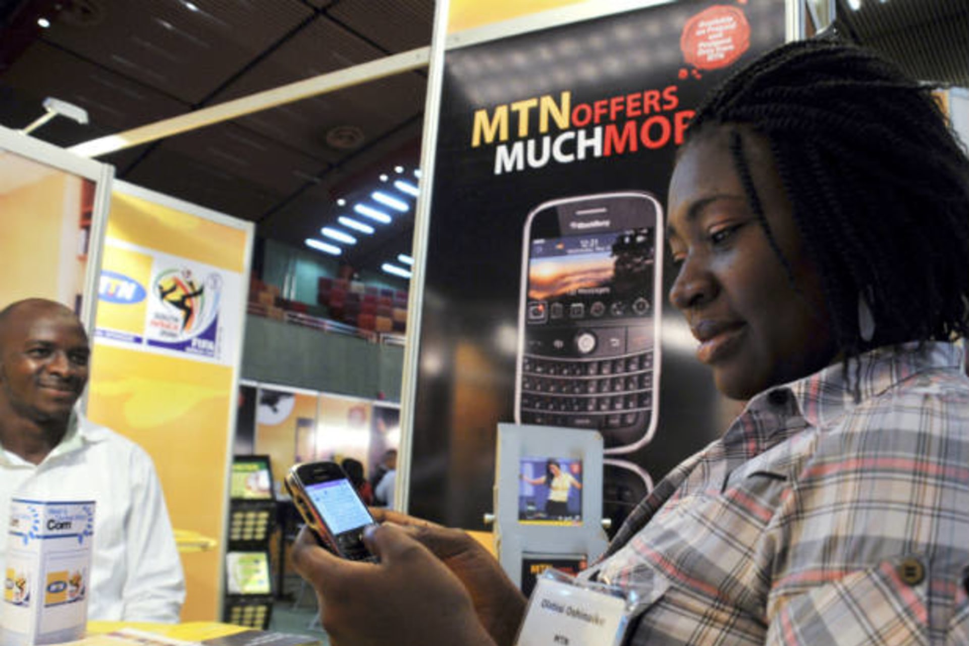 <p>A delegate checks a Blackberry handset at an exhibition stand during the West & Central Africa Com conference in Nigeria’s capital Abuja on June 18, 2009 (Afolabi Sotunde/Courtesy Reuters).</p>
