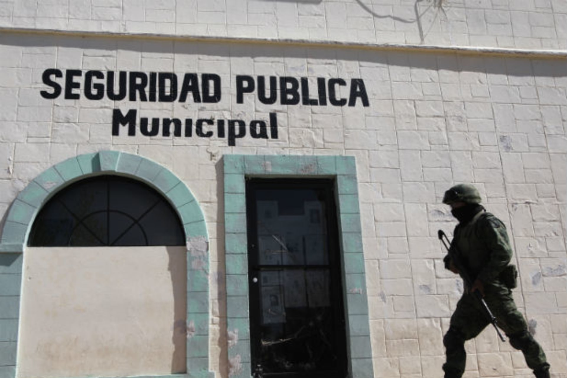 <p>A soldier walks past the police headquarters where Marisol Valles Garcia used to work as the police chief in Praxedis G. Guerrero (Stringer/Courtesy Reuters).</p>
