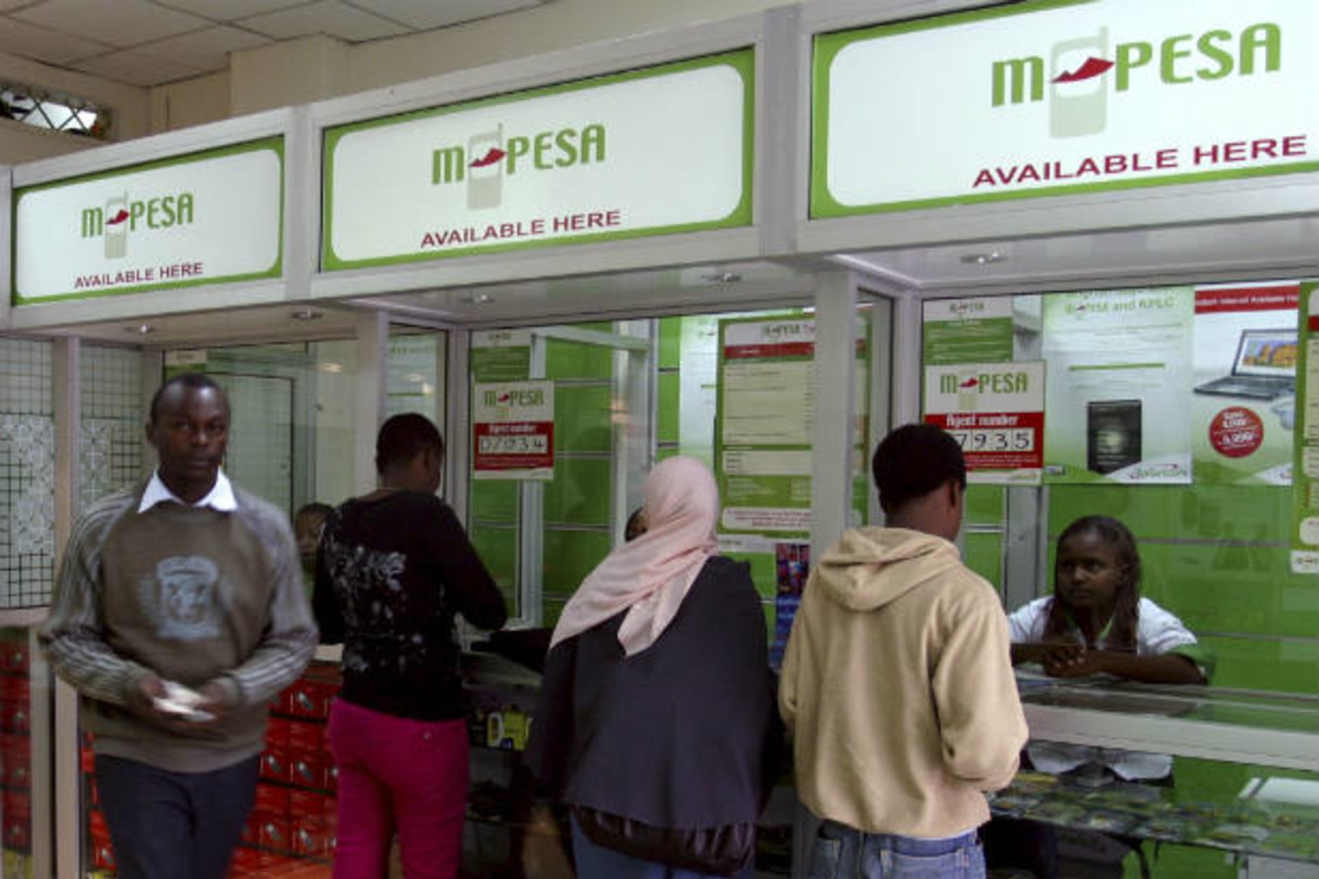 <p>A man leaves an M-Pesa booth after a transaction in Nairobi, Kenya on May 12, 2009 (Noor Khamis/Courtesy Reuters).</p>
