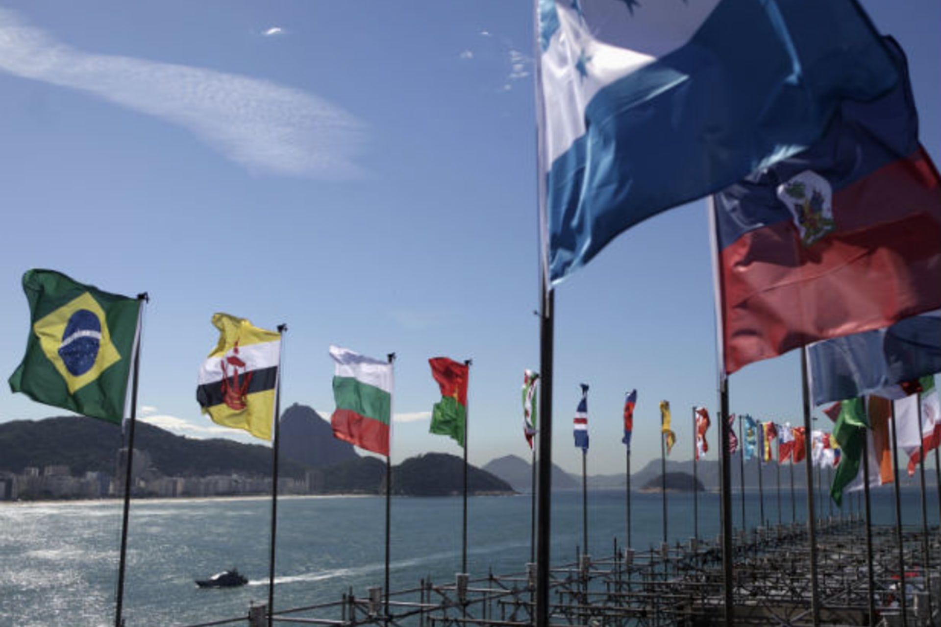 <p>A Brazilian Navy boat patrols the Copacabana beach as national flags flutter on the Copacabana Fort (Ricardo Moraes/Courtesy Reuters).</p>
