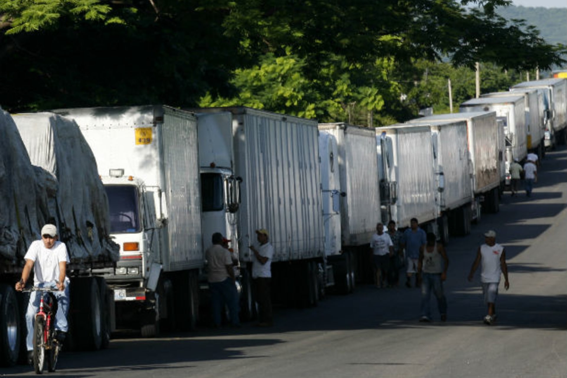 <p>Container trucks stand in line as they are stopped on border between El Salvador and Honduras</p>

