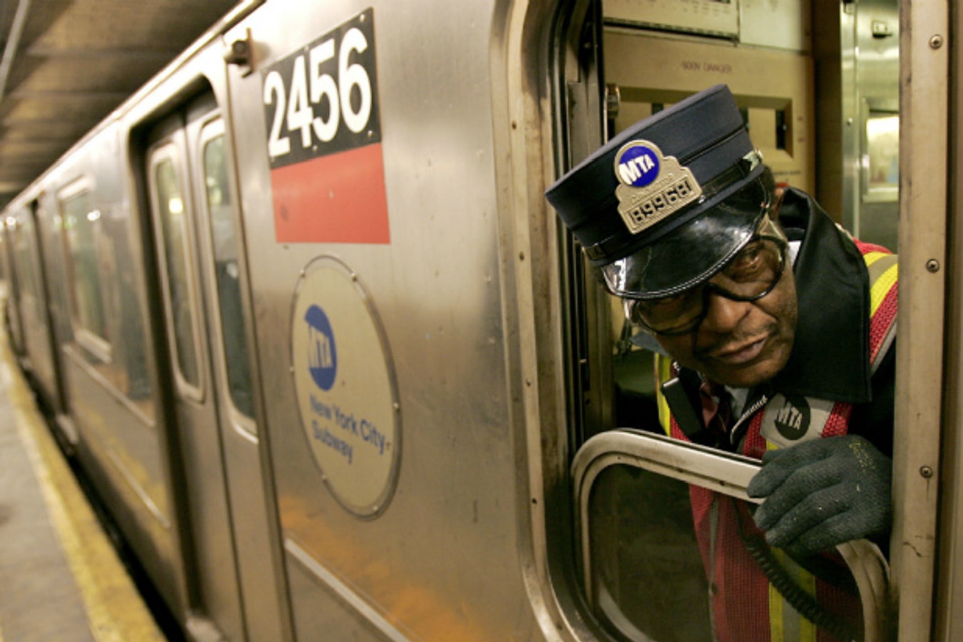 <p>A New York subway conductor checks the train doors before departing Columbus Circle station in December 2005 (Courtesy Reuters).</p>
