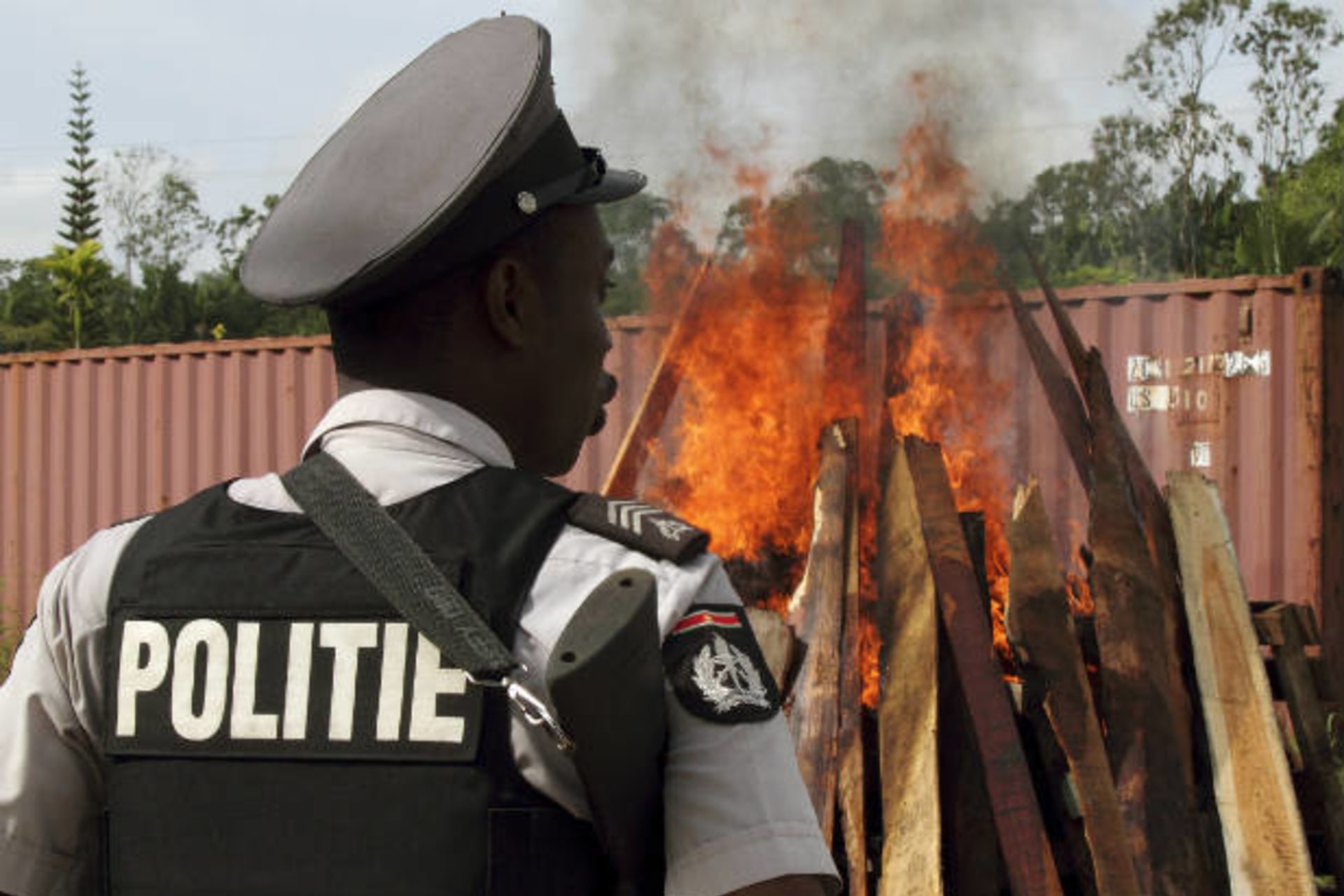 <p>A policeman watches as confiscated cocaine and marijuana are incinerated in Paramaribo, Suriname on April 19, 2011. Suriname is a transit point for drugs headed to Europe, Africa, and the United States (Ranu Abhelakh/Courtesy Reuters).</p>
