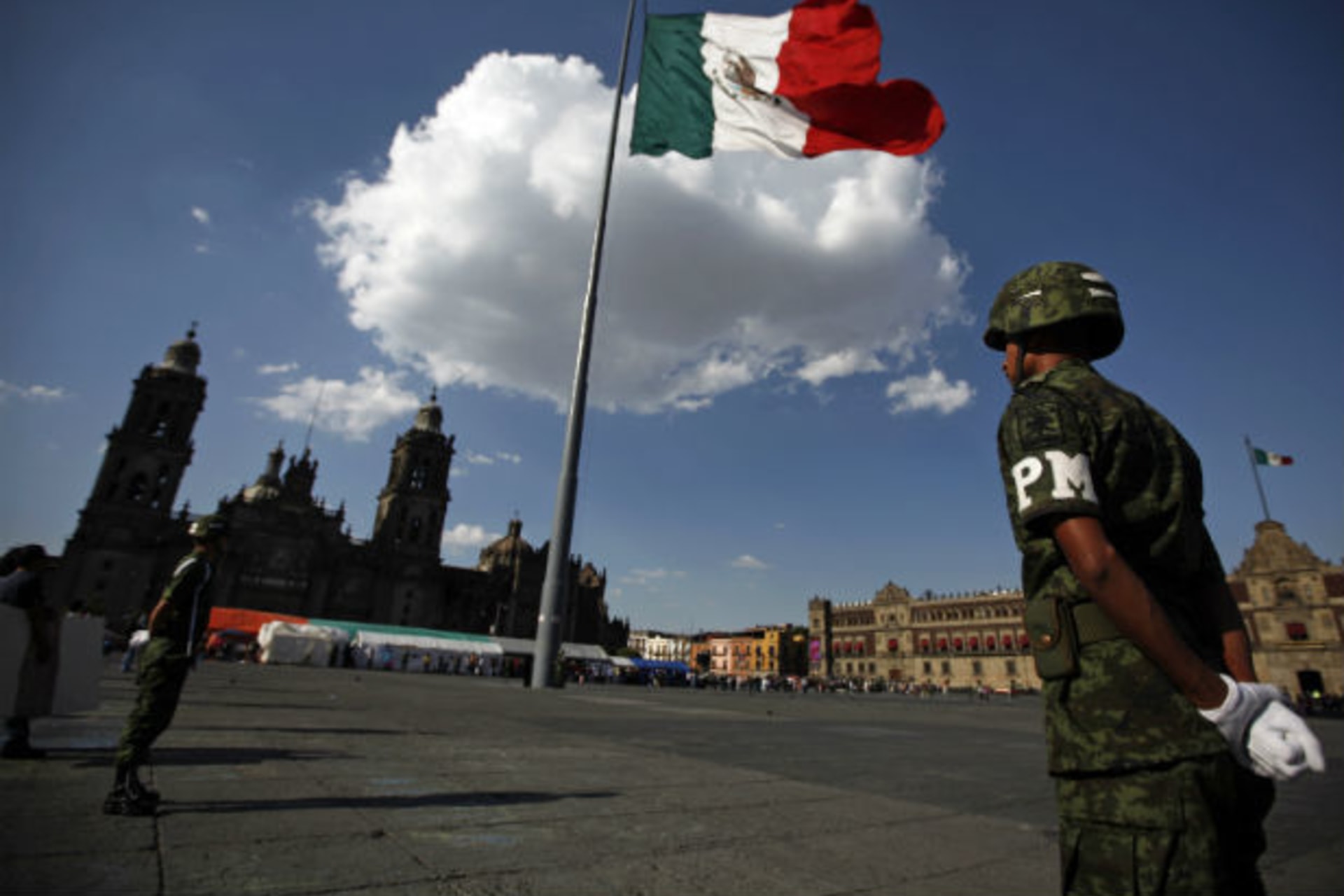 <p>Military police officials stand guard during the ceremony of the lowering of the flag at the Zocalo main square in Mexico City (Tomas Bravo/Courtesy Reuters).</p>
