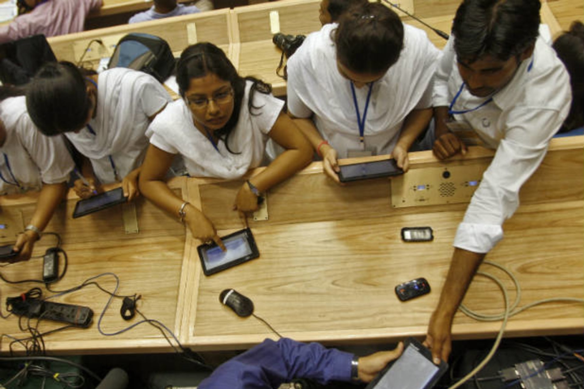 <p>Students use Aakash, a low-cost tablet computer, in New Delhi, India on October 5, 2011 (Parivartan Sharma/Courtesy Reuters).</p>

