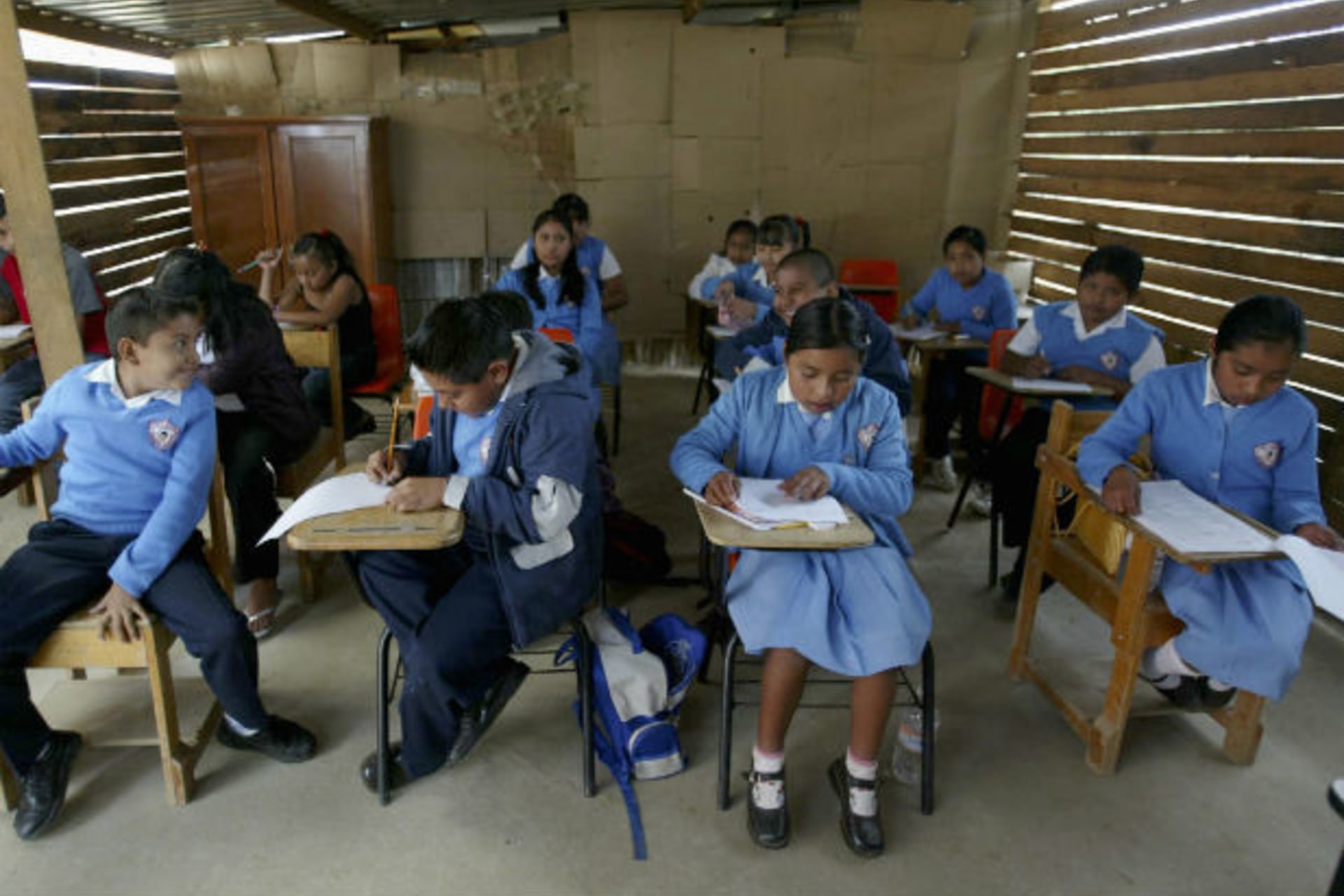 <p>Children sit in their classroom on their first day of school for six months in Oaxaca (Stringer/Courtesy Reuters).</p>
