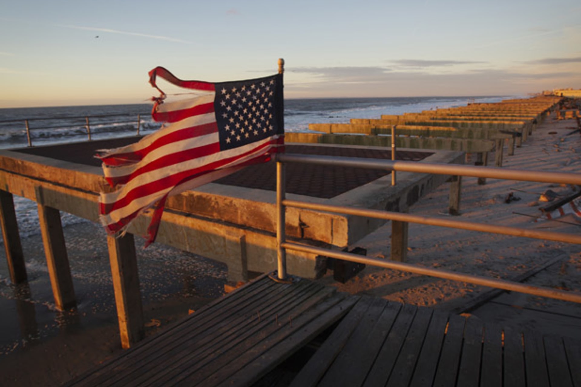 <p>An American flag stands on top of the devastated Rockaway beach boardwalk in Queens after Hurricane Sandy (Shannon Stapleton/ Courtesy Reuters).</p>