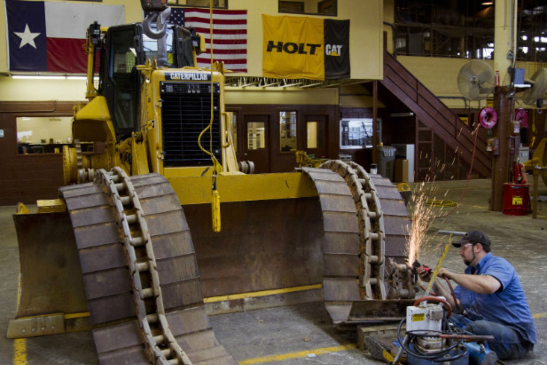 <p>A worker assembles tracks on a Caterpillar bulldozer at a Texan equipment dealer; the Peoria, Ill.-based manufacturer is expected to be a large beneficiary of improved trade opportunities with Colombia. (Richard Carson/Courtesy Reuters)</p>