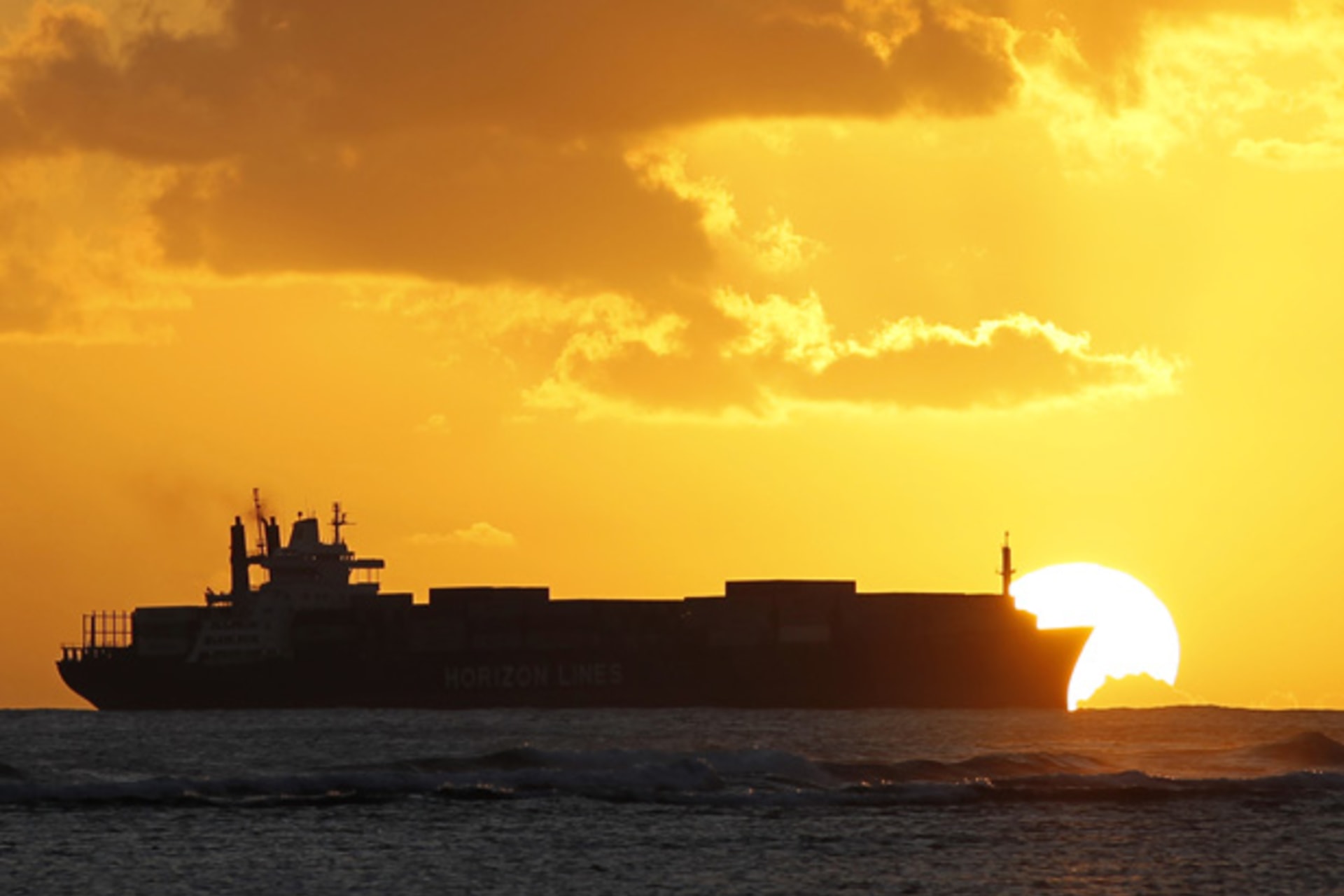 <p>cargo ship at sunset; trade</p>
