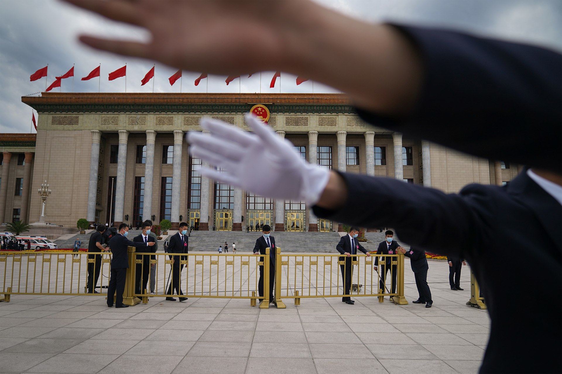 <p>Security guards block a journalist from taking photos in Beijing’s Tiananmen Square.</p>
