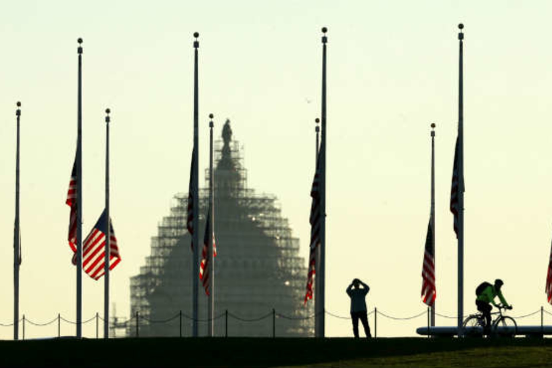 <p>American flags fly at half-staff to honor the victims of the Paris attacks. (Kevin Lamarque/Courtesy Reuters)</p>
