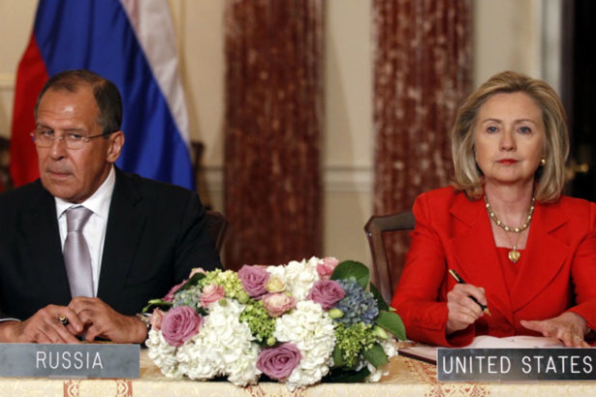 U.S. secretary of state Hillary Clinton and Russian foreign minister Sergey Lavrov look up during a signing ceremony at the State Department in Washington on July 13, 2011 (Kevin Lamarque/Courtesy Reuters).
