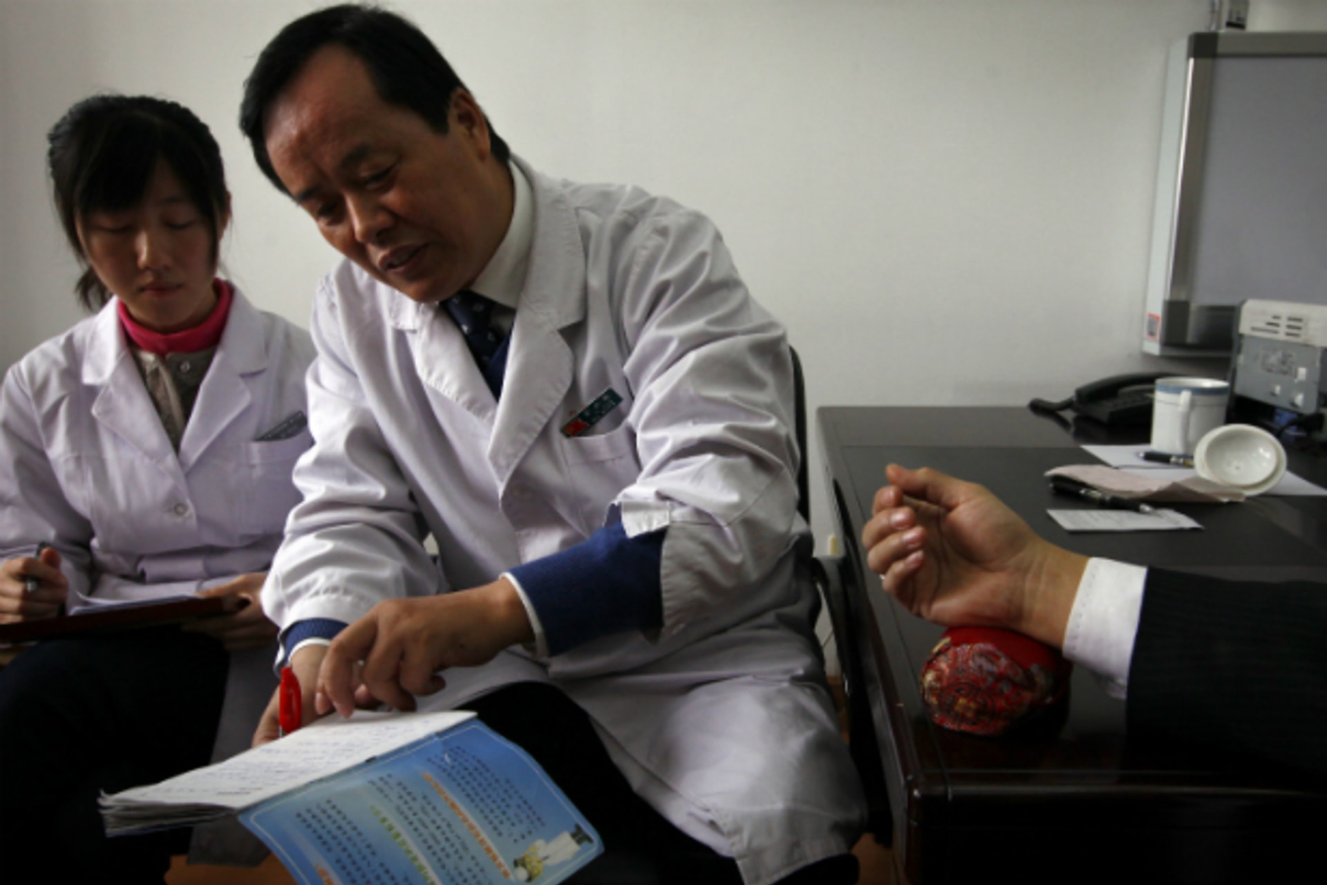 <p>A diabetes patient rests his arm on a table for diabetes specialist Doctor Tong Xiao Lin (C) during a medical check-up at the Guanganmen Chinese medicine Hospital in Beijing March 19, 2012. (David Gray/Courtesy Reuters)</p>